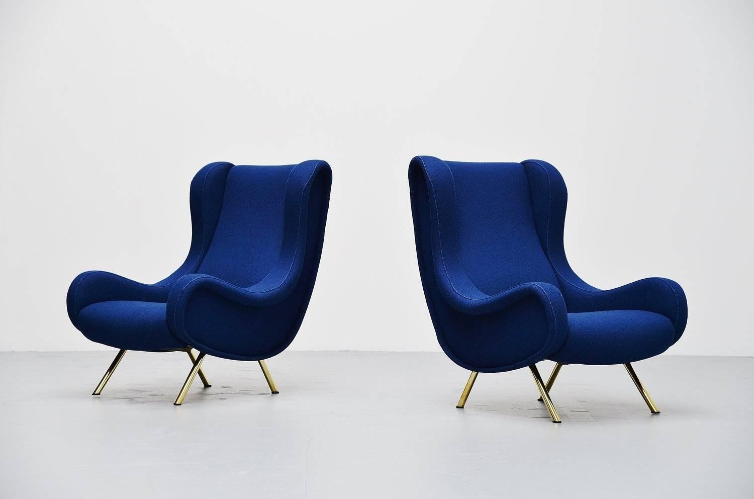 Fantastic iconic lounge chair set designed by world known designer Marco Zanuso for Arflex, Italy 1951. These two lounge chairs are newly upholstered with Tonica 751 fabric by Kvadrat and is upholstered like its supposed to and we used the best