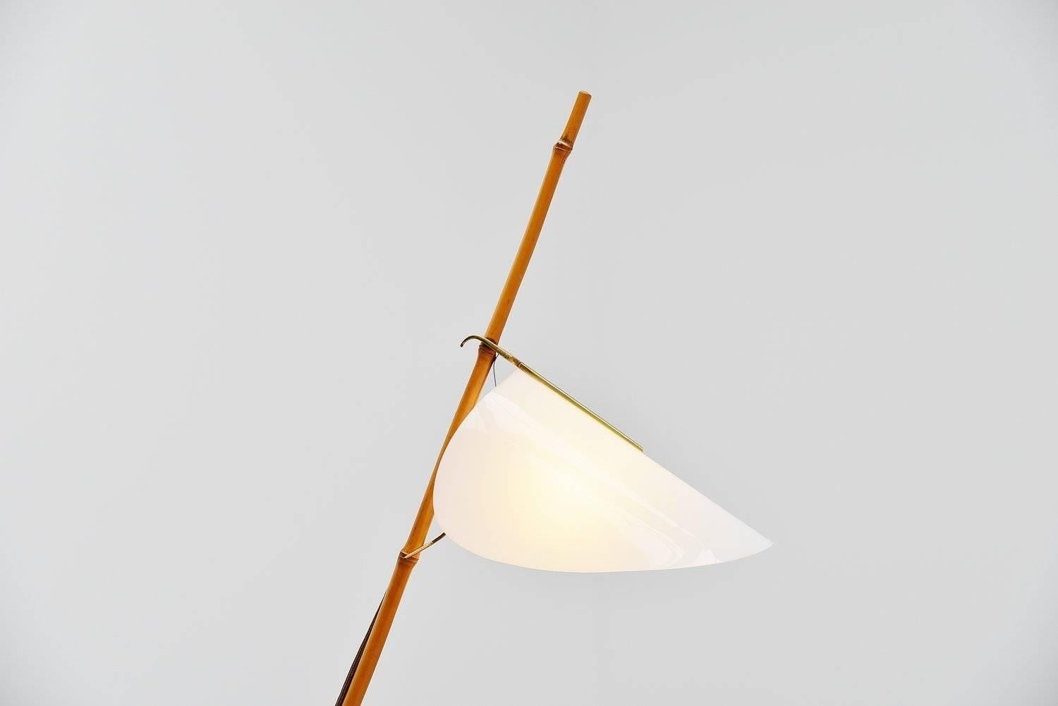 Stunning bamboo floor lamp by J.T. Kalmar, Austria, 1950. This lamp has a solid brass foot with bamboo and a plexi and brass detailed shade that is adjustable in height. The lamp is in fantastic original condition and works perfectly. Gives very