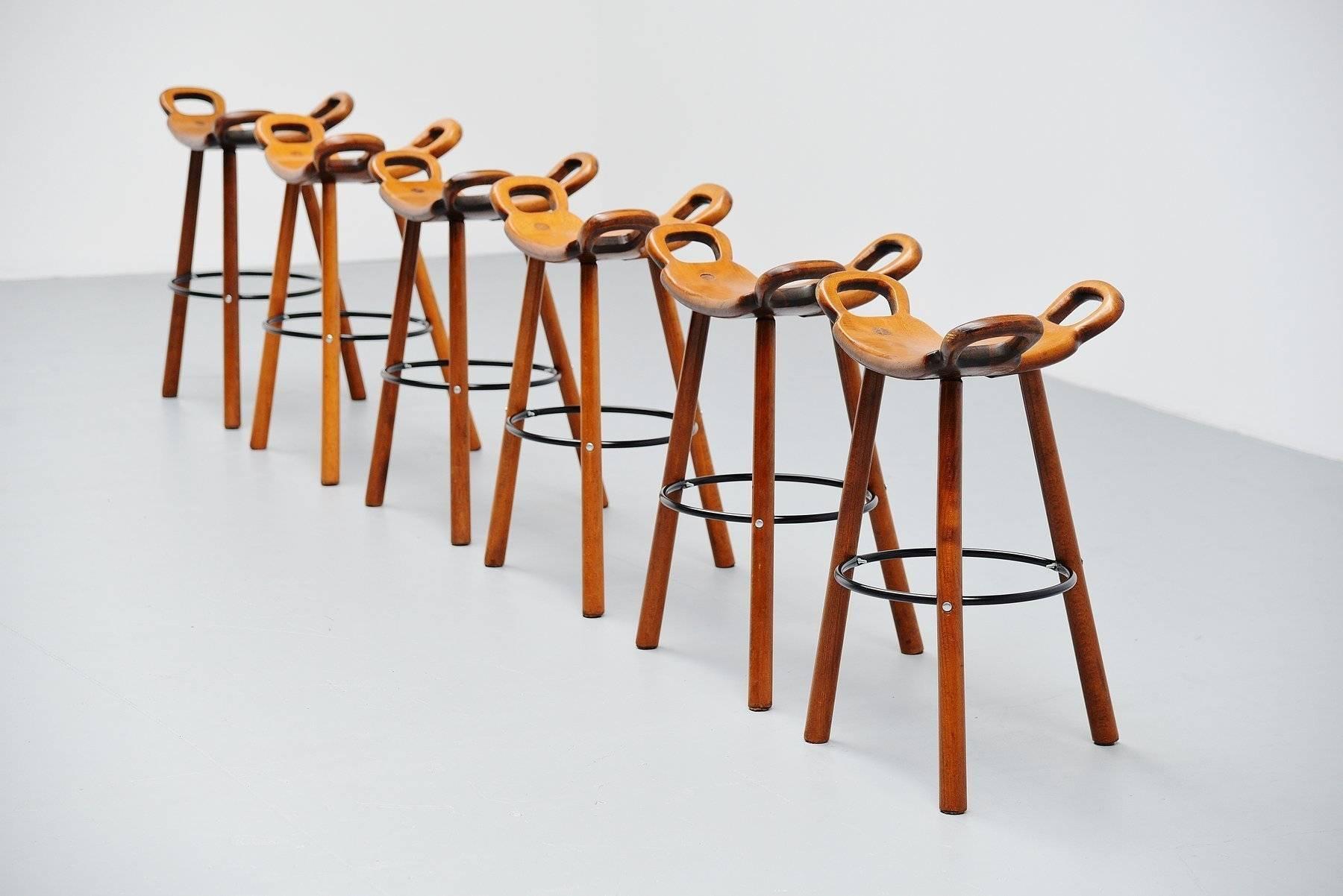 Very nice set of six bar stools attributed to Carl Malmsten, Sweden, 1950. These stools are very nicely shaped and made of solid birch wood, dark stained. The stools have a black metal supporting foot rest ring. These stools are in original