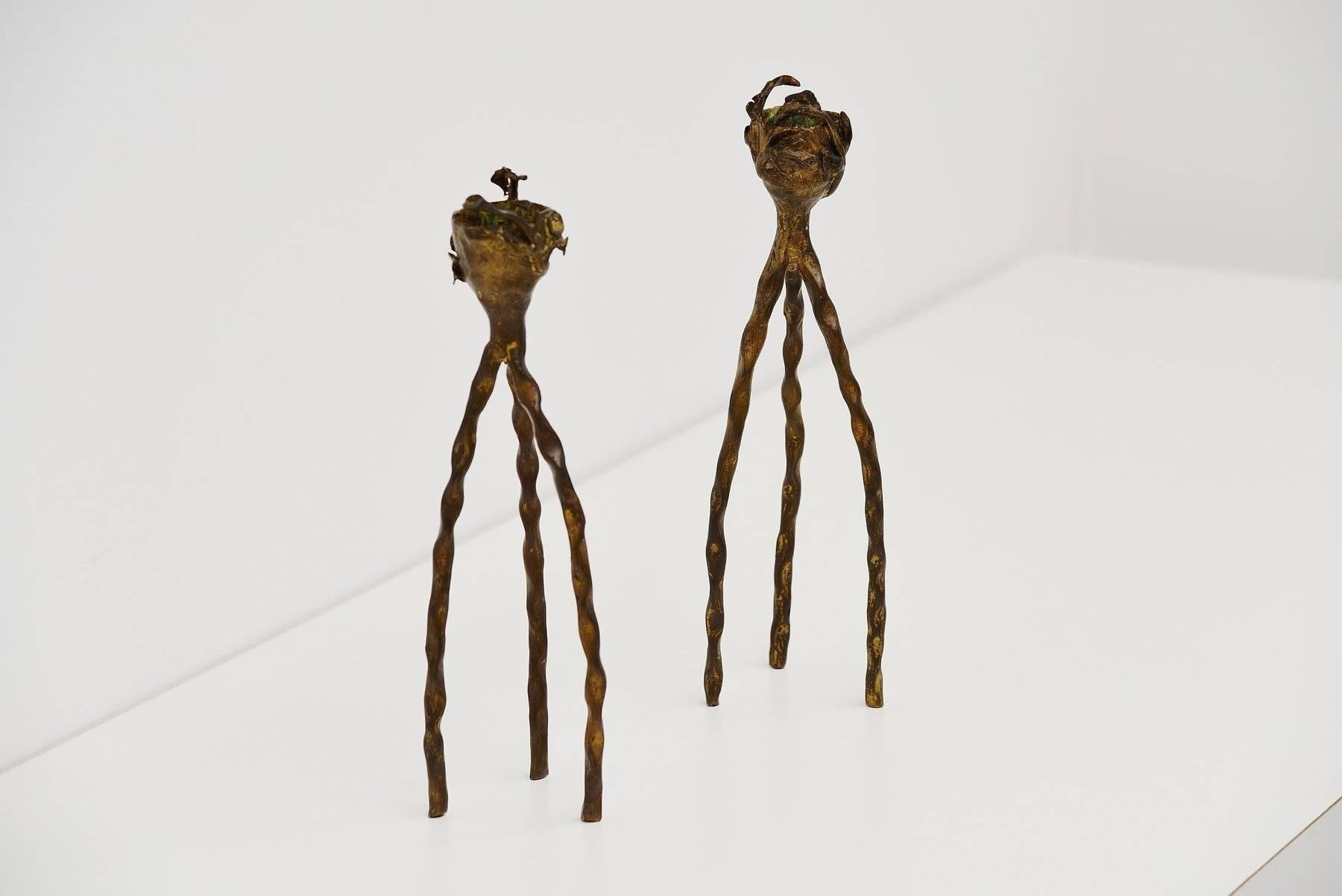 Very nice subtle pair of candle holders made by unknown designer or manufacturer in tehs tyle of Alberto Giacometti. These are made of solid bronze and are beautiful handcrafted, heavy candle holders with nice floral details. Slight patinated