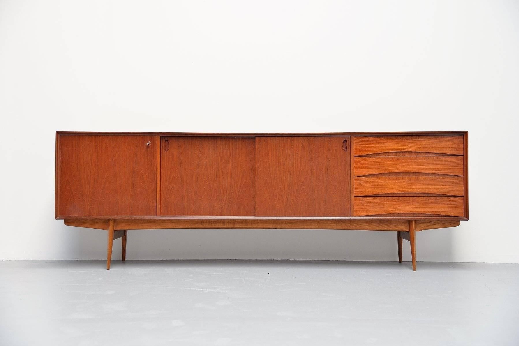 Very nice and quality sideboard designed by Oswald Vermaercke for V-Form, Belgium, 1959. This amazing credenza has a very nice and warm teak color and is in fully original condition. The designs by Oswald Vermaercke are visibly inspired by the