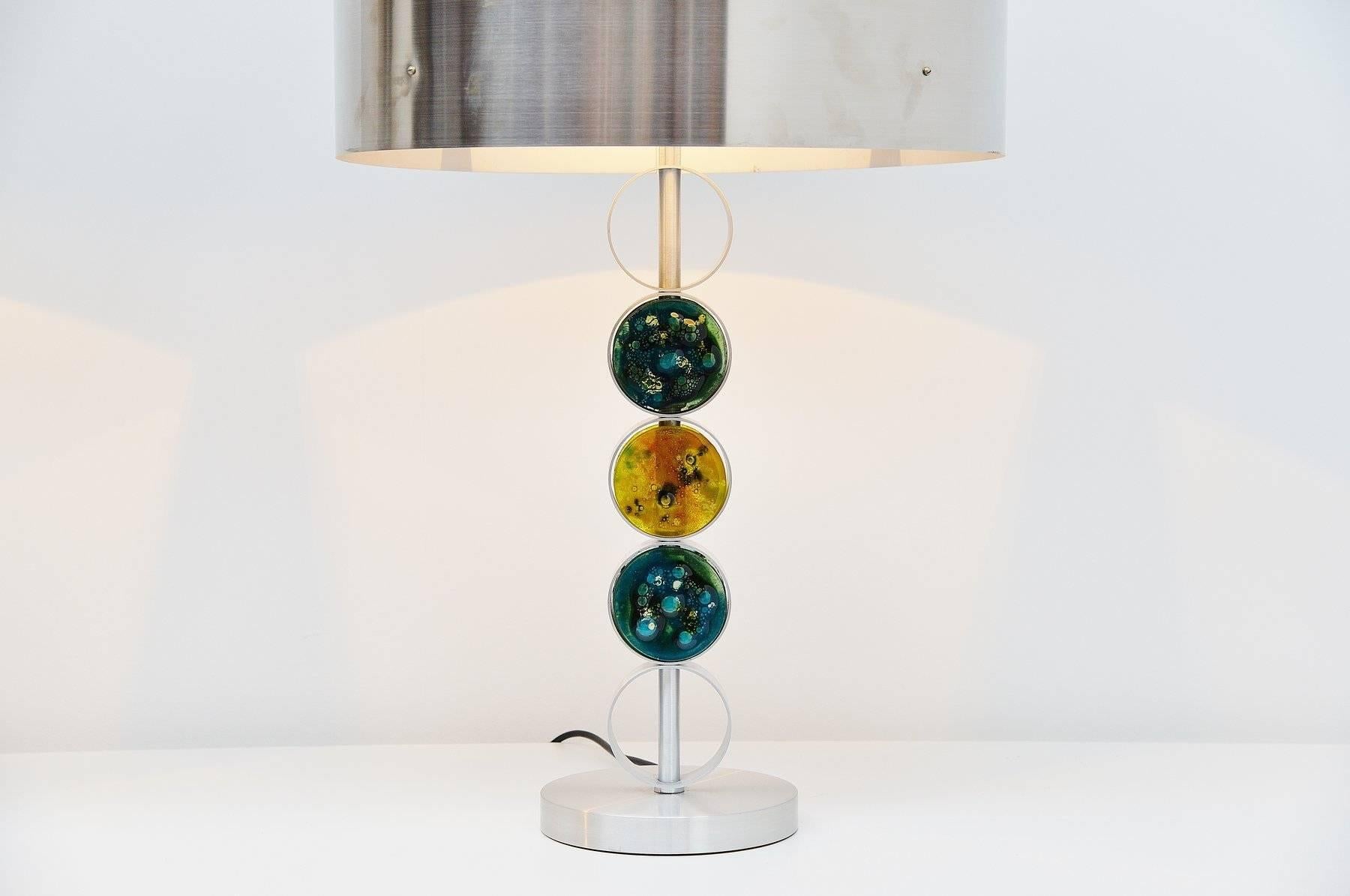 Very nice and oversized table lamps designed and made by Raak Amsterdam, Holland, 1972. This amazing pair of lamps is made of brushed steel and aluminum and the bases have glass details planet shaped. The lamps are in very good original condition