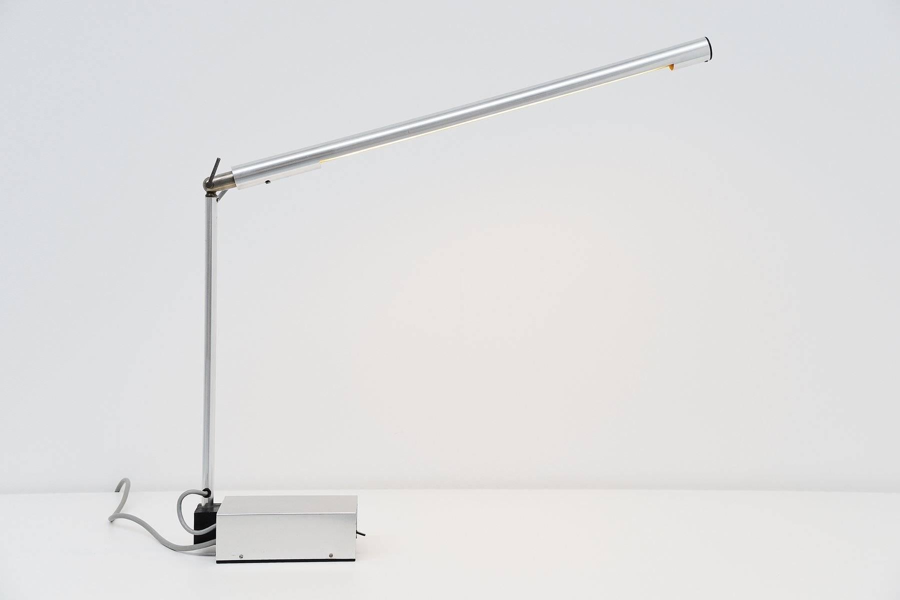 Beautiful modernist desk lamp model KMll is designed by Gerald Abramovitz for Best & Lloyd, Ltd., Birmingham, United Kingdom, 1961. This superb made and shaped table lamp was only produced for 2 years from 1961-1963. This lamp has a weighted base