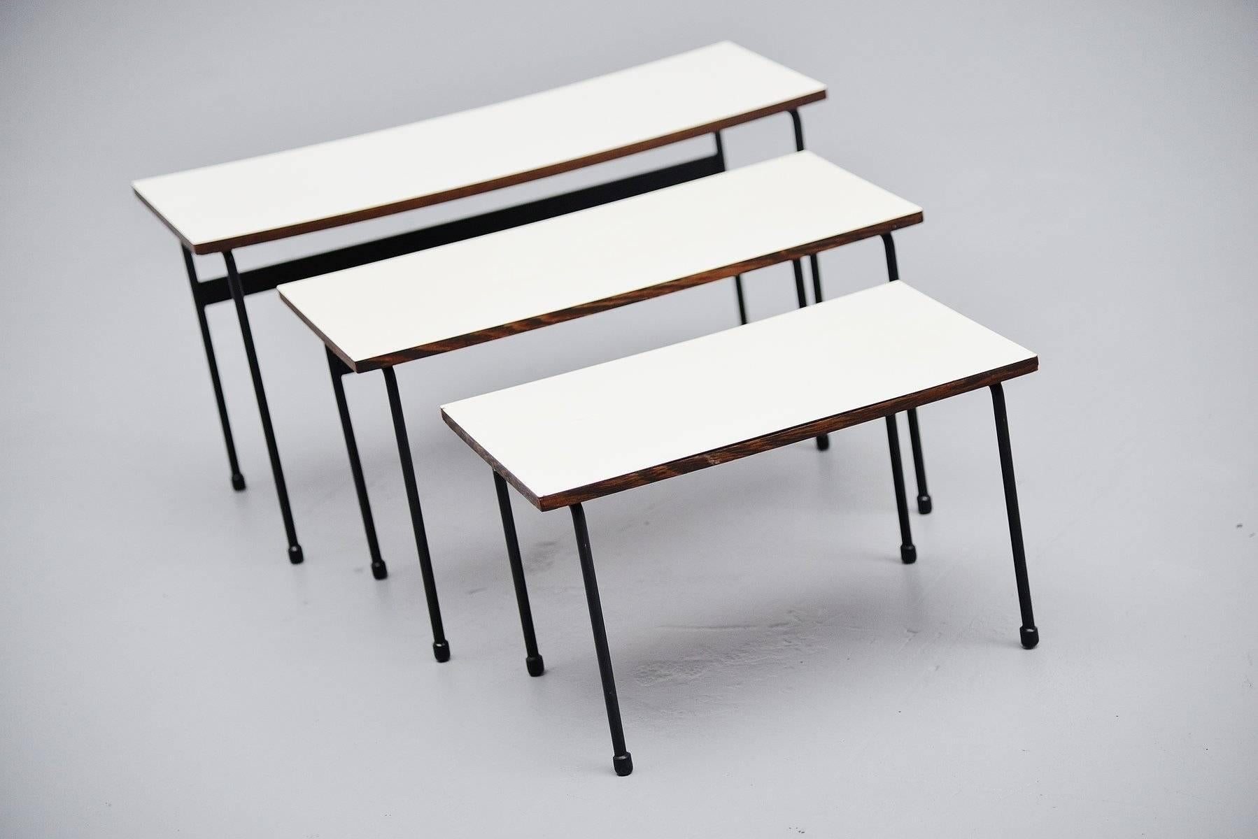 Very nice and rare set of nesting tables designed by Martin Visser for 't Spectrym Bergeyk, Holland 1956. These tables are called Twello and they exist in different editions. These have a wenge wooden edge and white formica tops. The frames are made