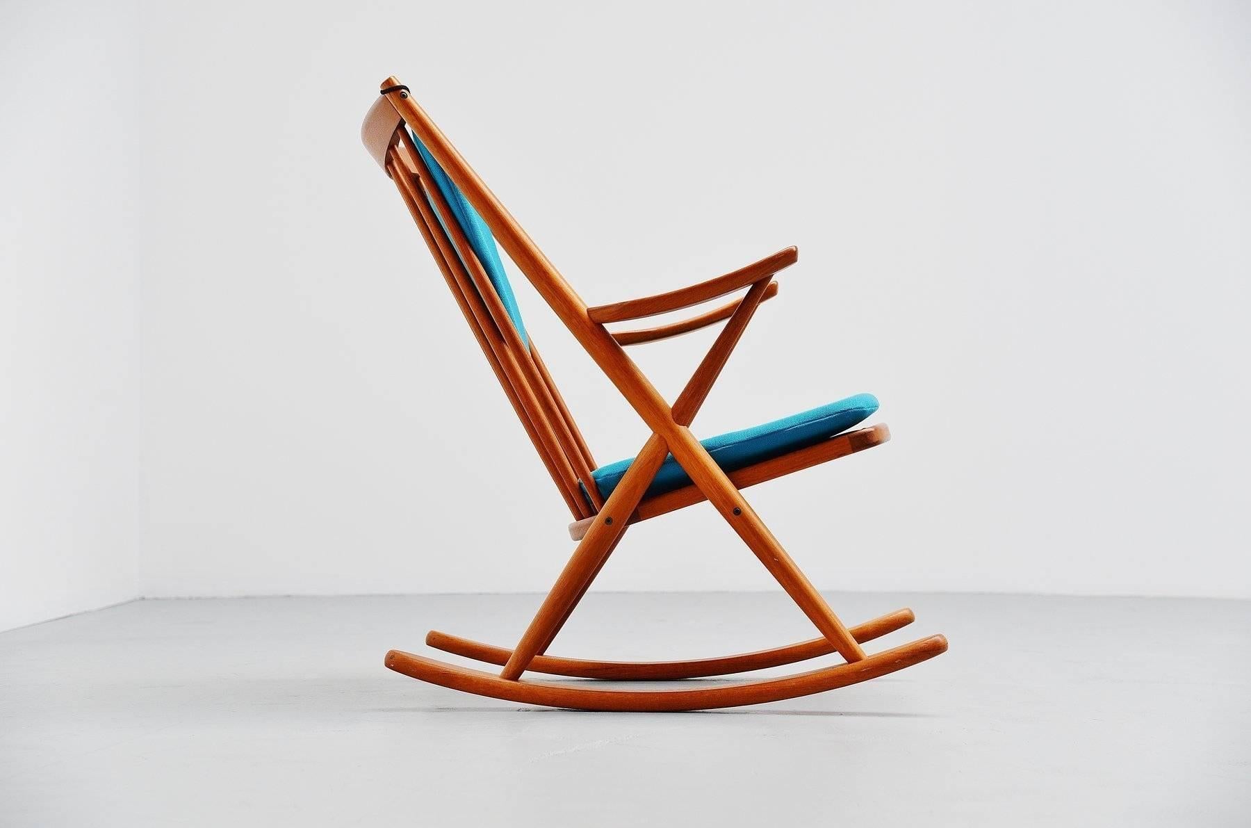 Very nice sculptural rocking chair designed by Frank Reenskaug for Bramin, Denmark, 1960. This rocking chair is made of solid teak and its newly upholstered with ocean blue fabric by Kvadrat. The chairs frame is in excellent condition and its marked