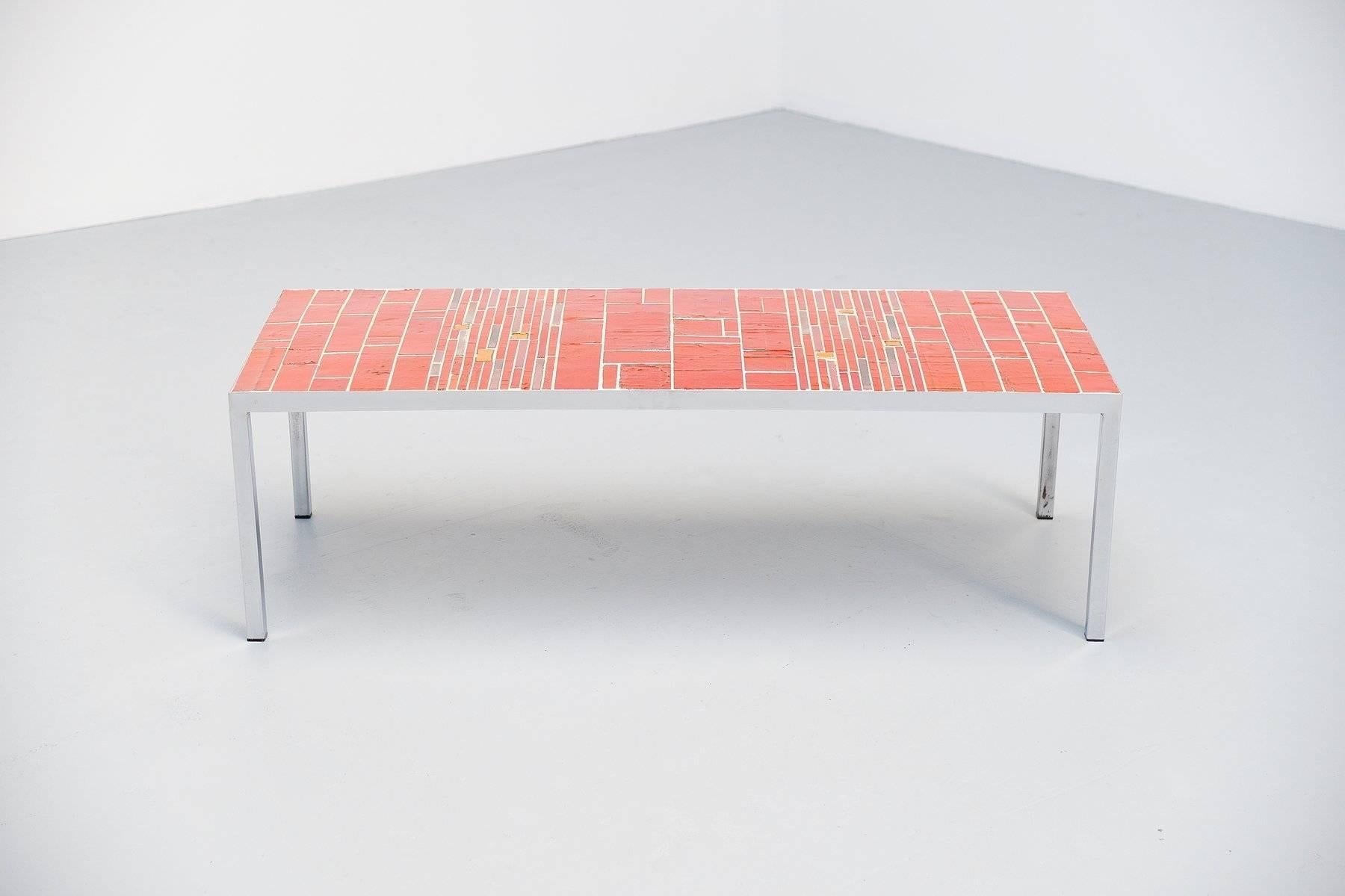 Very nice unique coffee table designed by Rogier Vandeweghe produced in the atelier of Amphora, Belgium, circa 1960. This table has a chrome plated metal frame and the top has a red ceramic tiles inlay. The table looks like a work of art that is