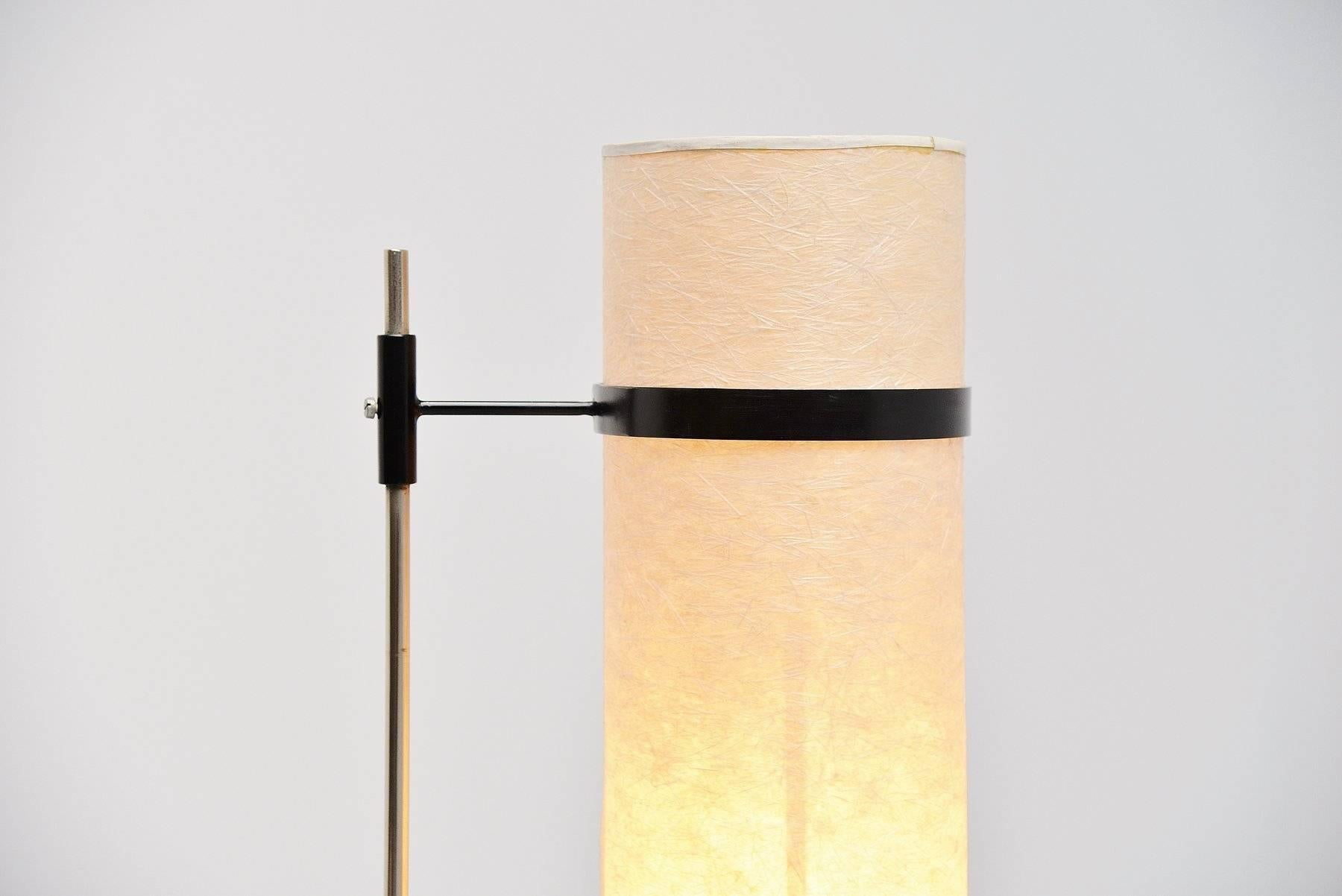 Very nice shaped modernist floor lamp made in the manner of Kho Liang Ie, Holland, 1960. This floor lamp has a weighted V-shaped base and a nickel-plated bar with black lacquered shade holder and rice paper shade. The lamp is in fully original