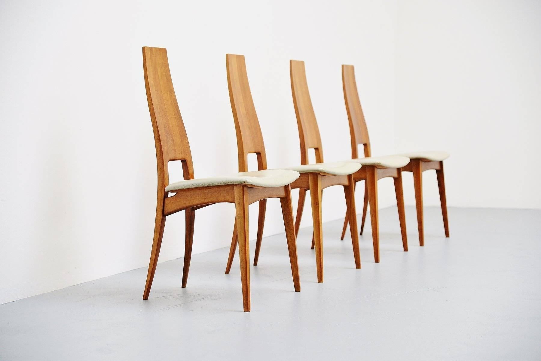 Very nice set of four slim dinner chairs in the manner of Carlo Mollino, Italy, 1950. Very nicely made and typical Italian shaped chairs in solid cherrywood and very light grey leather upholstery. Chairs are in original condition, wood has some