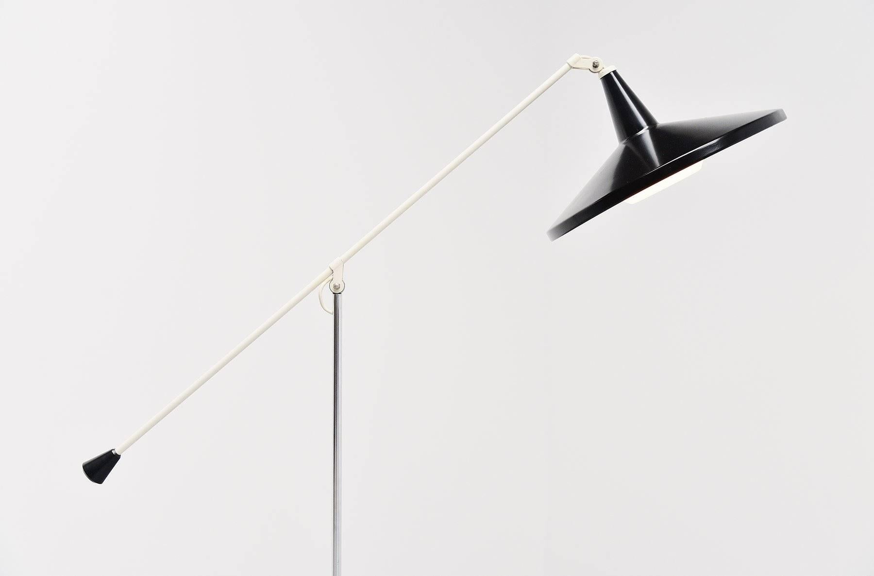 Very nice Industrial floor lamp designed by Wim Rietveld for Gispen Culemborg, Holland, 1955. This floor lamp has an off-white base and a chrome middle arm. The adjustable arm is made of white lacquered metal and has a black plastic end. The shade