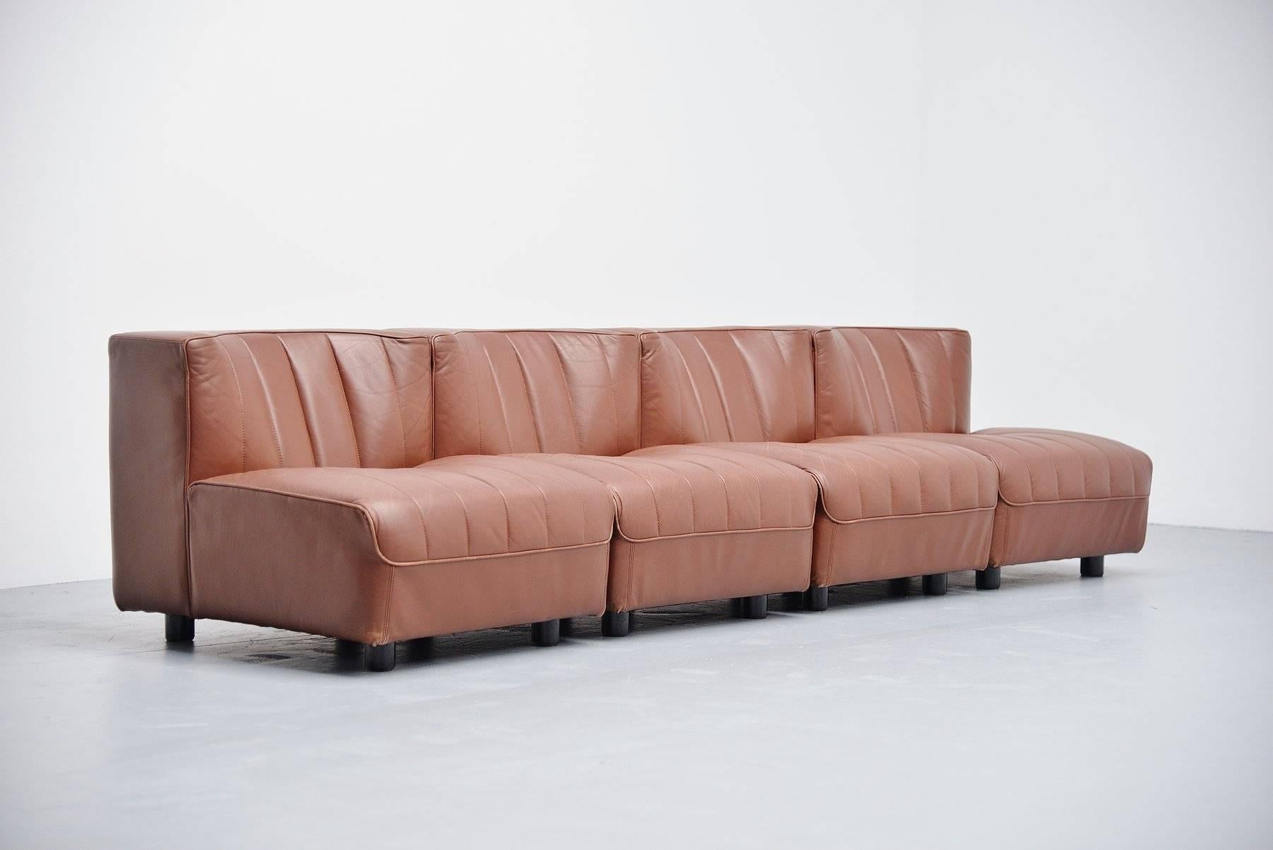 Element sofa from the 9000 series designed by Tito Agnoli for Arflex, Italy, 1969. This sofa exists of four separate elements that can be made one sofa or 2 two-seat sofa's or four single chairs. Multi functional sofa elements. Sofa has a wooden