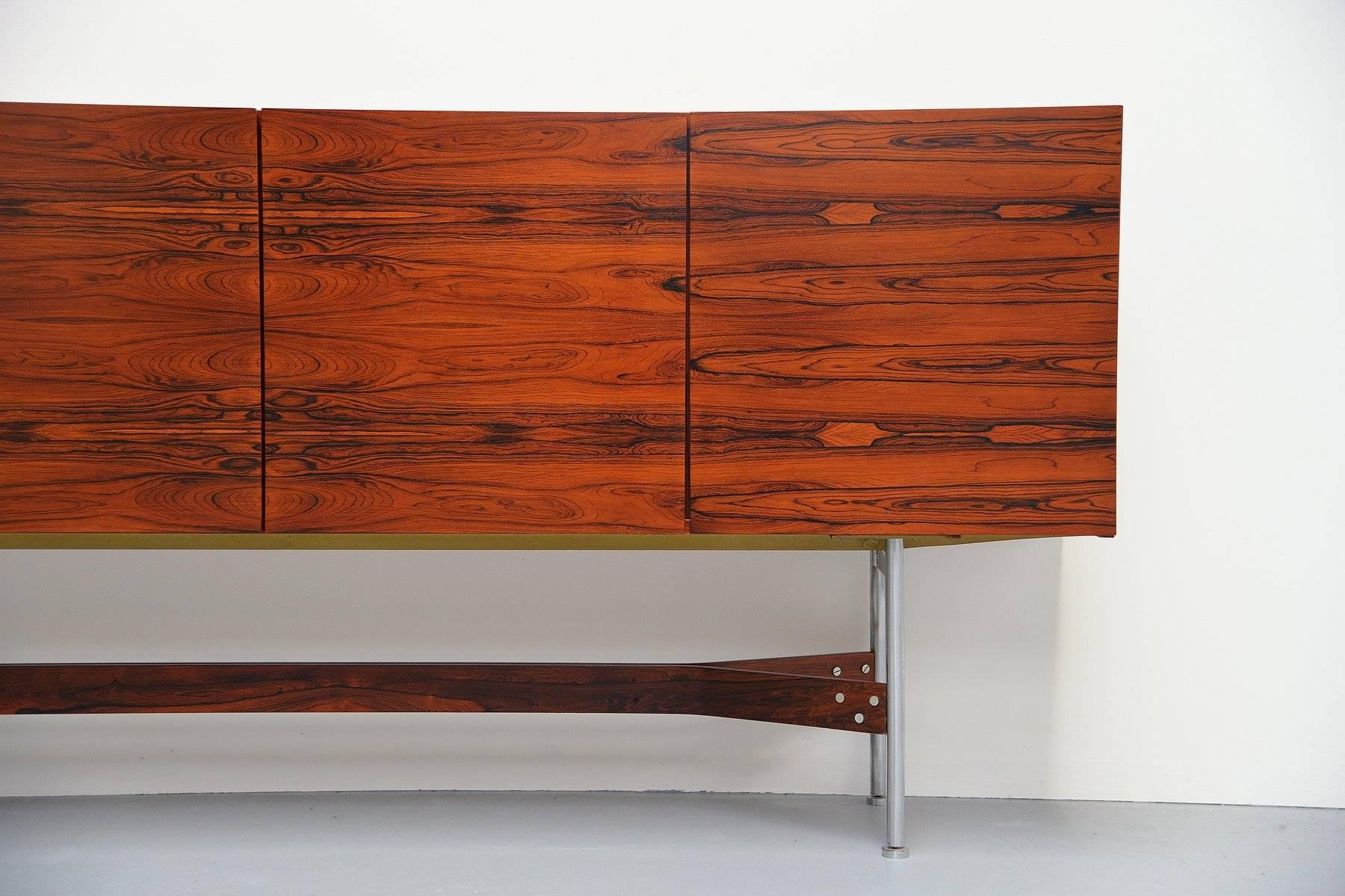 Extraordinary high sideboard designed by Rudolf Glatzel produced by Fristho Franeker, Holland, 1962. This sideboard is from the G-series and was model GLR-230. It has an amazing rosewood grain and brushed steel tubular frame connected with a ply