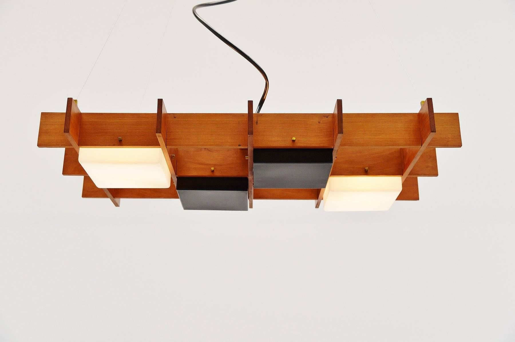 Beautiful extraordinary ceiling fixture made by Esperia, Italy, 1950. This ceiling lamp has a solid teak wooden frame and two square plexi shades and two black lacquered metal shades. Very nice quality made lamp with brass details and the shade