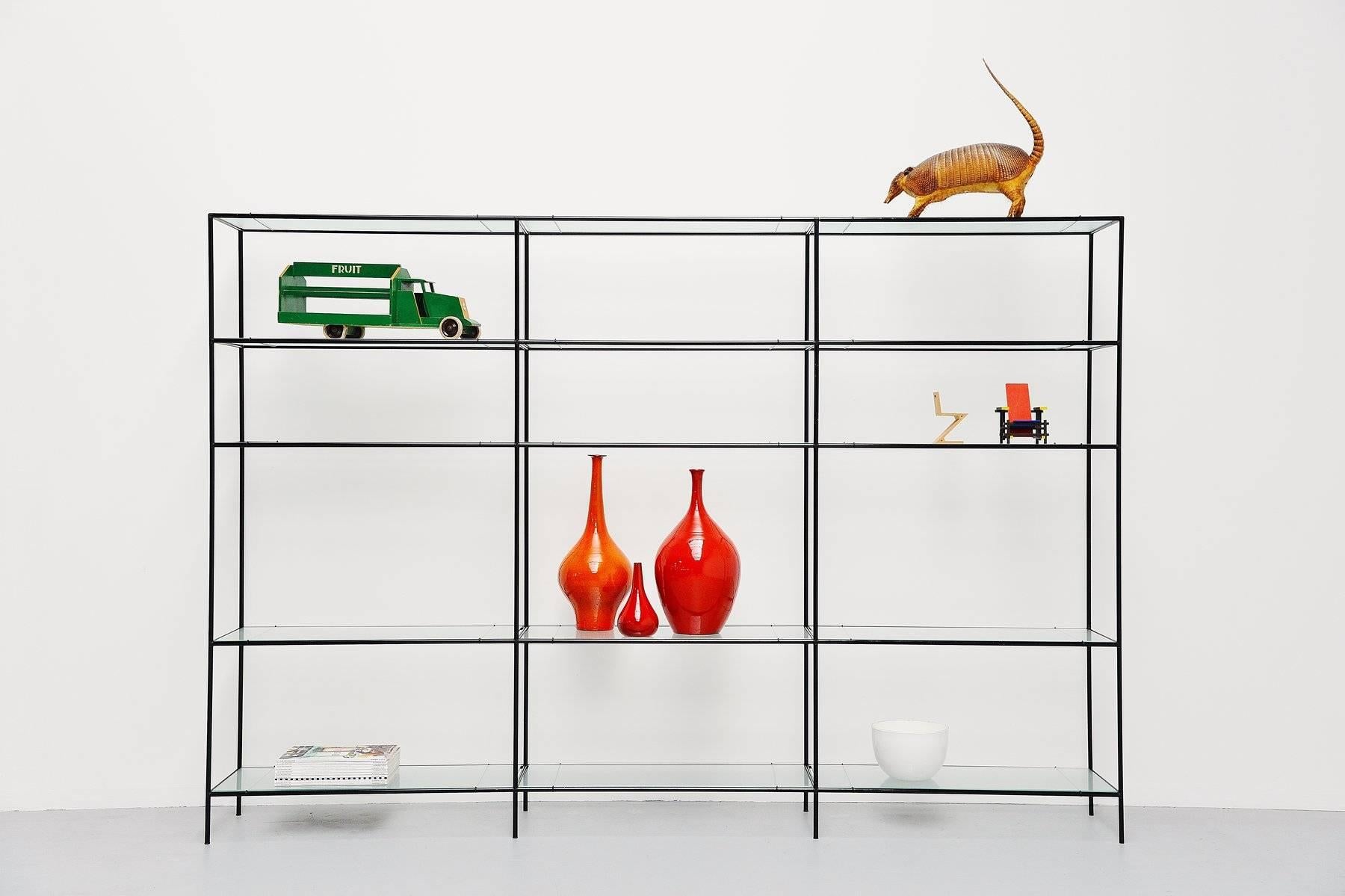 Very nice modern shaped 'Abstracta' shelving system designed by Poul Cadovius produced by Royal System, Denmark, 1960. This timeless system exists of black lacquered metal tubes with connectors and float glass shelves on very nice metal wire shelve