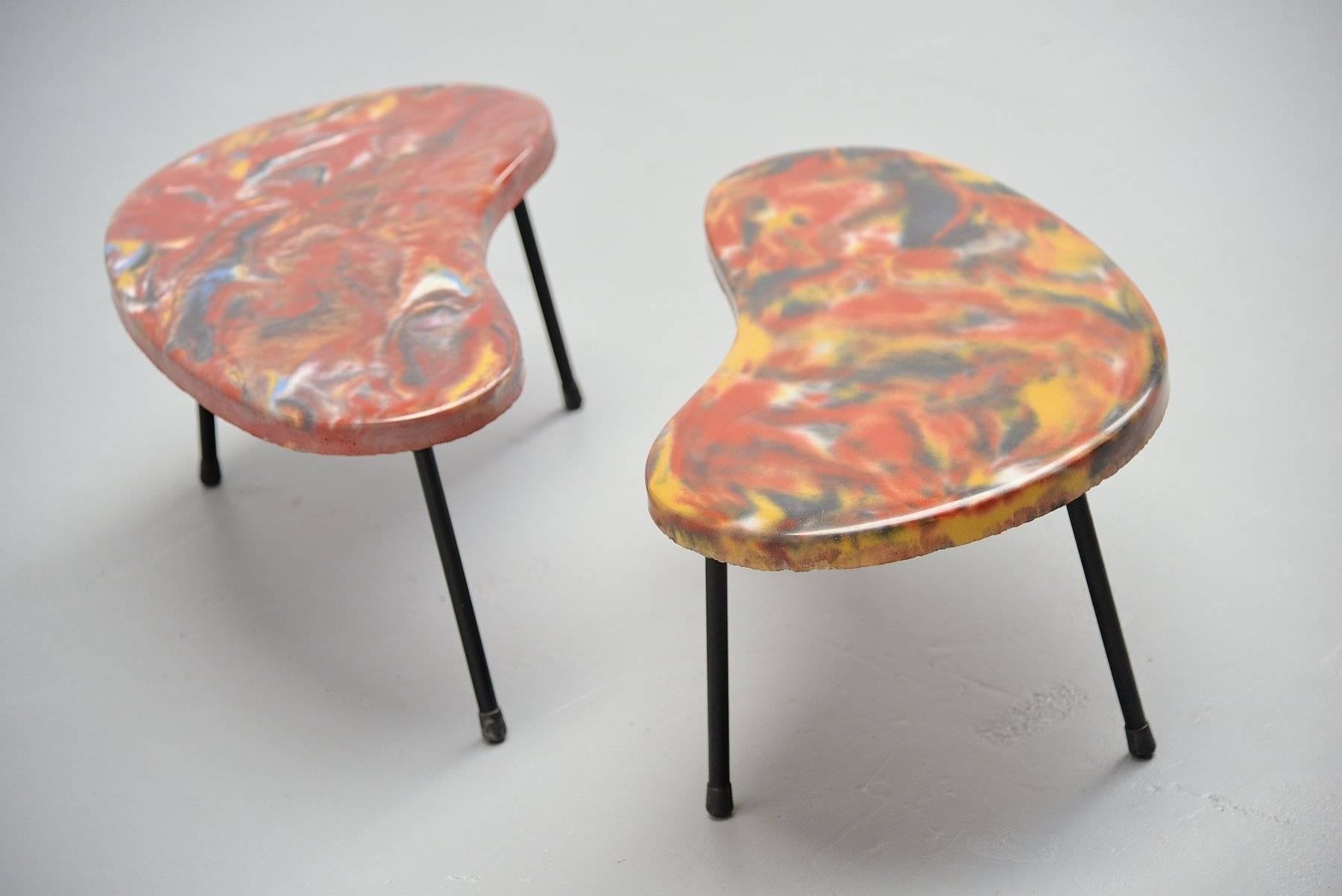 Very special small side tables kidney shaped, France, 1960. These tables are very special, I cannot find anything on the internet that comes close to these. They are made of solid concrete, painted and finished with transparent epoxy. The legs are