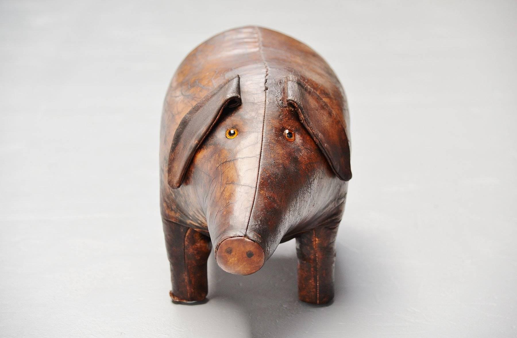 Iconic leather pig shaped footstool designed by Dimitri Omersa manufactured by Liberty's for Abercrombie & Fitch, United Kingdom, 1960. This footstool has a very nice patina from age and usage and is still complete and intact. This pig has a very