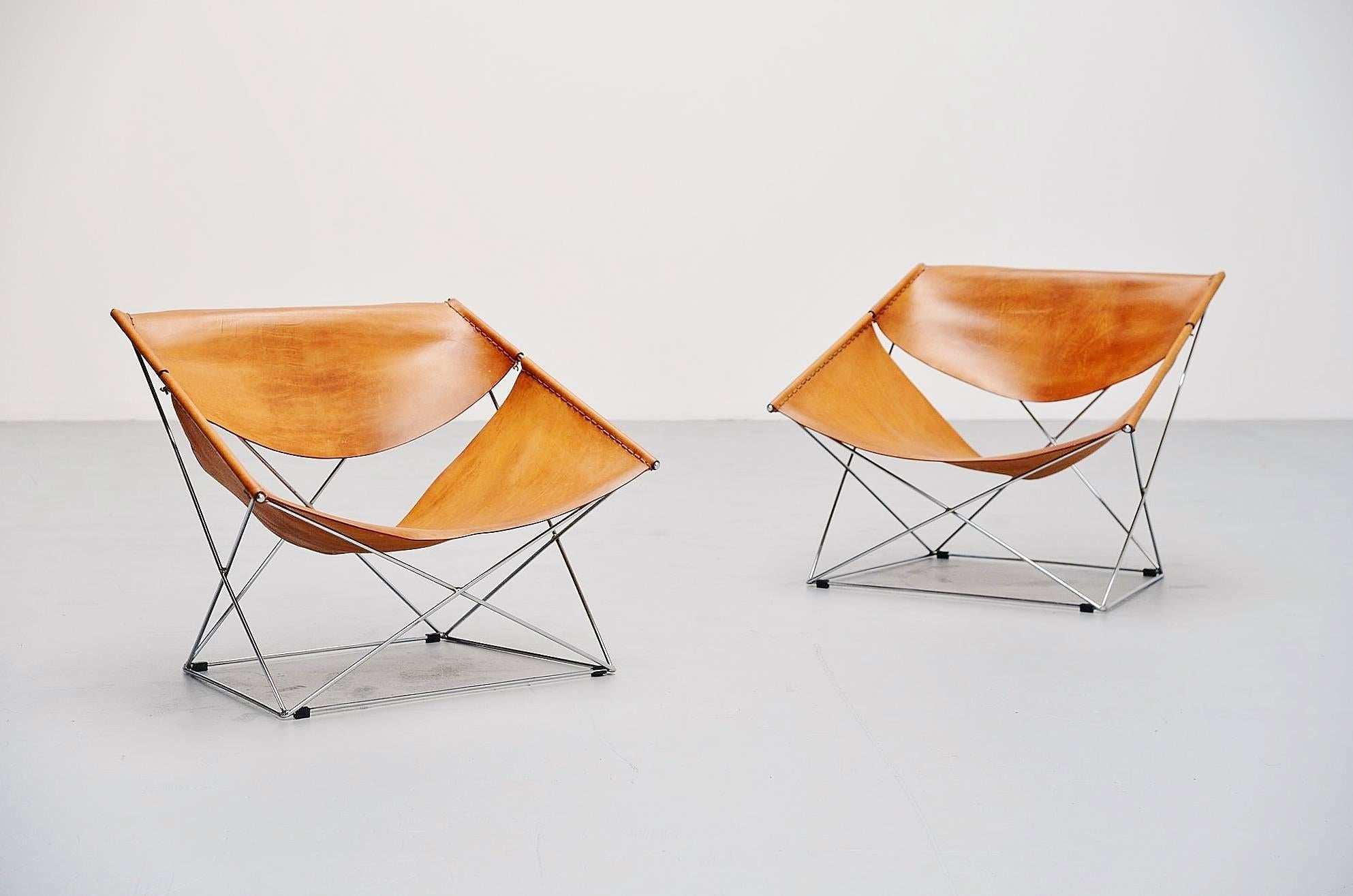 Amazing pair of lounge chairs designed by Pierre Paulin, manufactured by Artifort, Holland, 1963. These chairs are an amazing pair of early editions with fantastic patina to the natural leather seats. The frame is made of high quality chrome plated