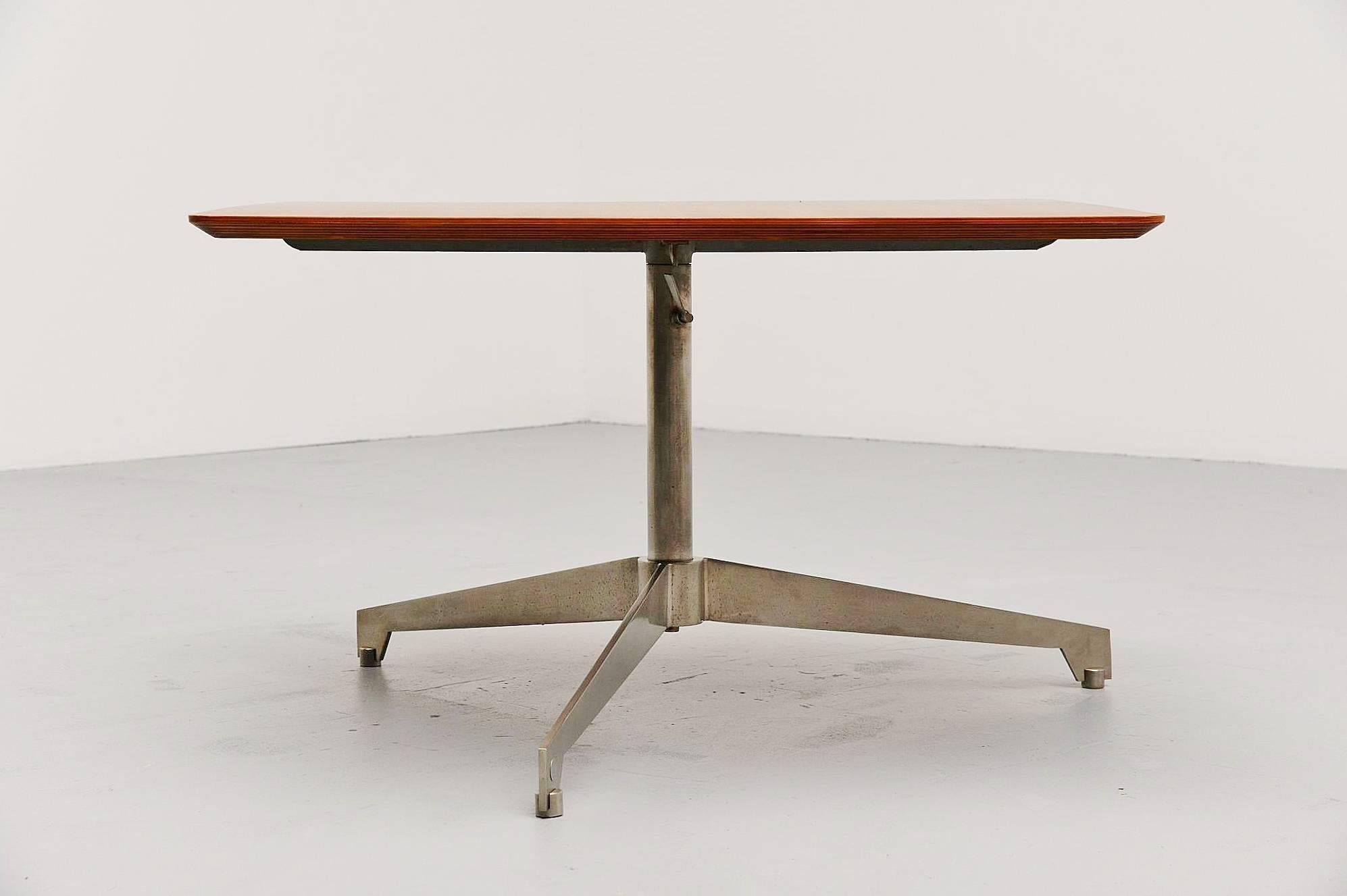 Very nice and unusual adjustable coffee/working table designed by Osvaldo Borsani, manufactured by Tecno, Italy 1960. This table has a chrome-plated metal tripod base which is adjustable in height, from 53 to 73 cm. The top is made of walnut veneer