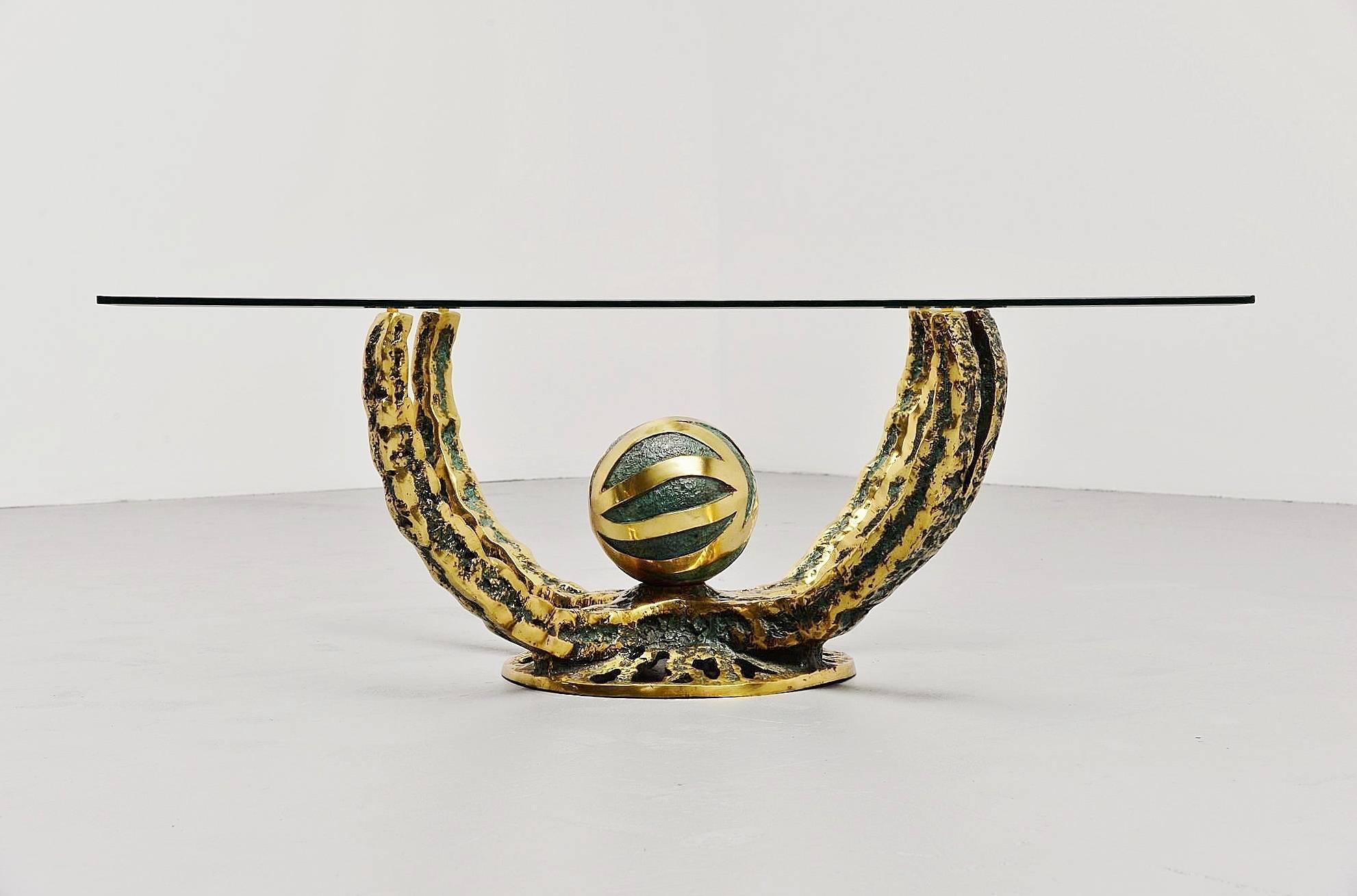 Spectacular coffee table made and designed by Henri Fernandez, France, 1972. This table has a solid bronze octopus shaped base, partly patinated in green. The square glass top has a facet edge and is in very good condition. The table is very nicely