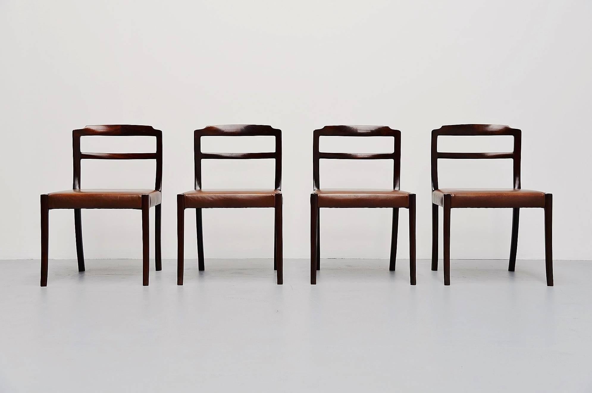 Nice set of four dining chairs designed by Ole Wanscher, manufactured by A.J. Iversen, Denmark, 1965. These chairs have mahogany frames and brown quality leather seats. The backs have very nice dovetail connections. Very nice set of four quality