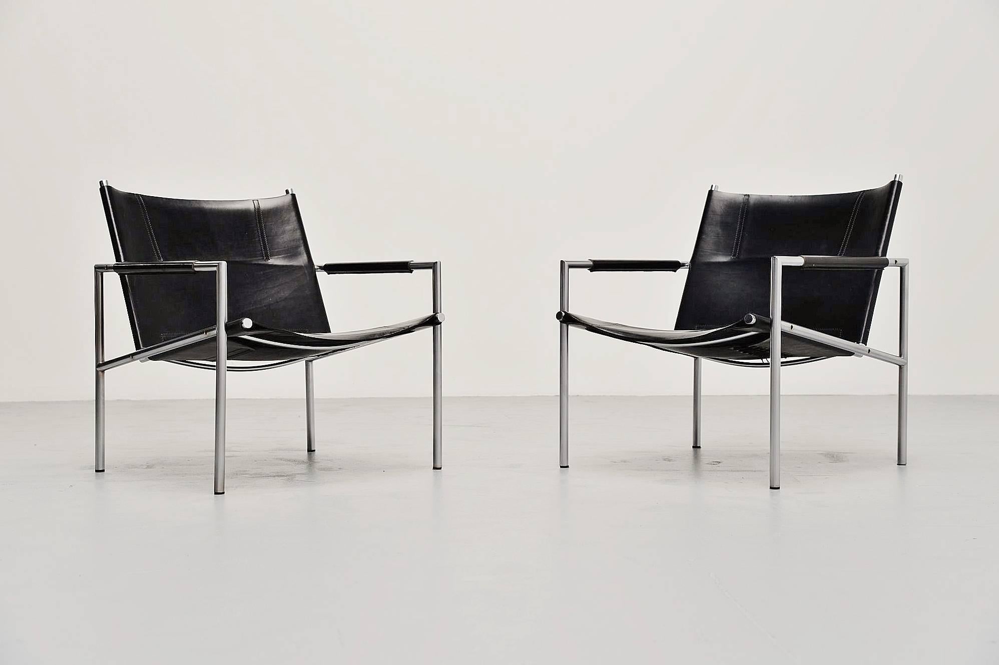 Modernist pair of lounge chairs model SZ01 designed by Martin Visser for 't Spectrum, Holland 1965. These chairs have a brushed steel tubular frame and very thick black saddle leather seats and arm rests finishing, a nice detail is the leather belt