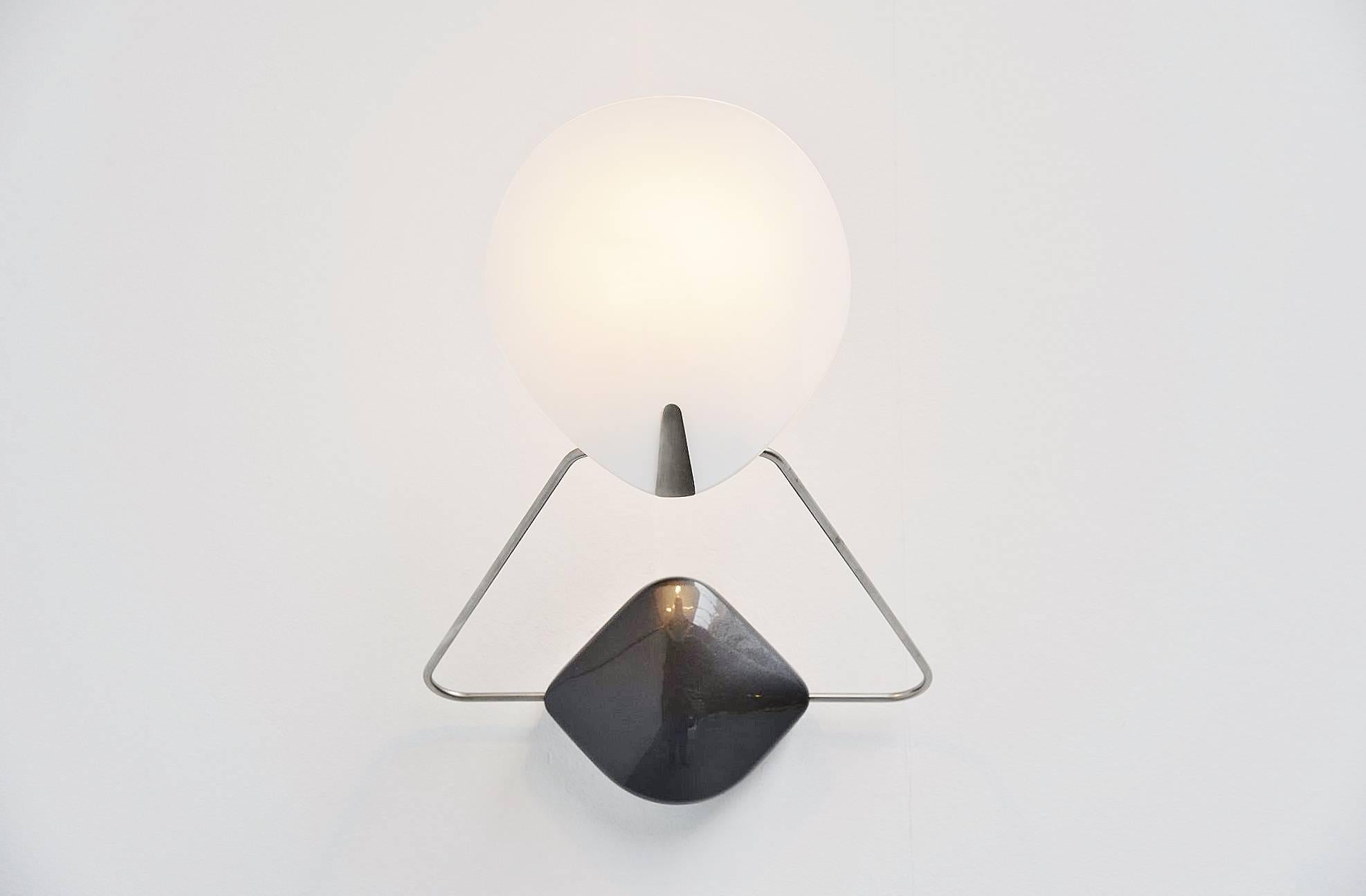 Rare wall lamp model 'Bali' designed by Paolo Rizzatto, manufactured by Arteluce, Italy, 1977. This lamp has a dark grey lacquered metal wall plate, a chrome plated adjustable arm with a white glass shade. The lamp gives very nice light when lit and