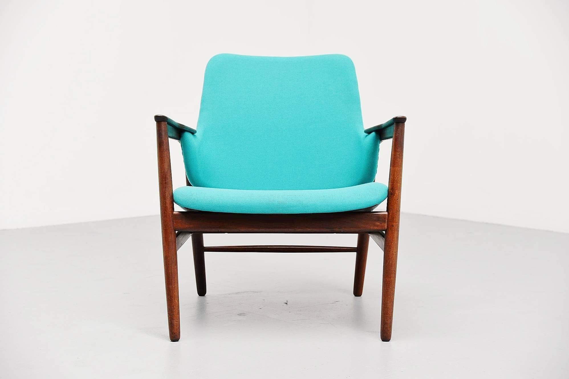 Super rare easy chair designed by Ib Kofod Larsen, manufactured by Christensen & Larsen Cabinetmakers, Denmark, 1953. This chair has a solid teak frame and is newly upholstered with turquoise upholstery. The chair is a real beauty, typical Ib Kofod