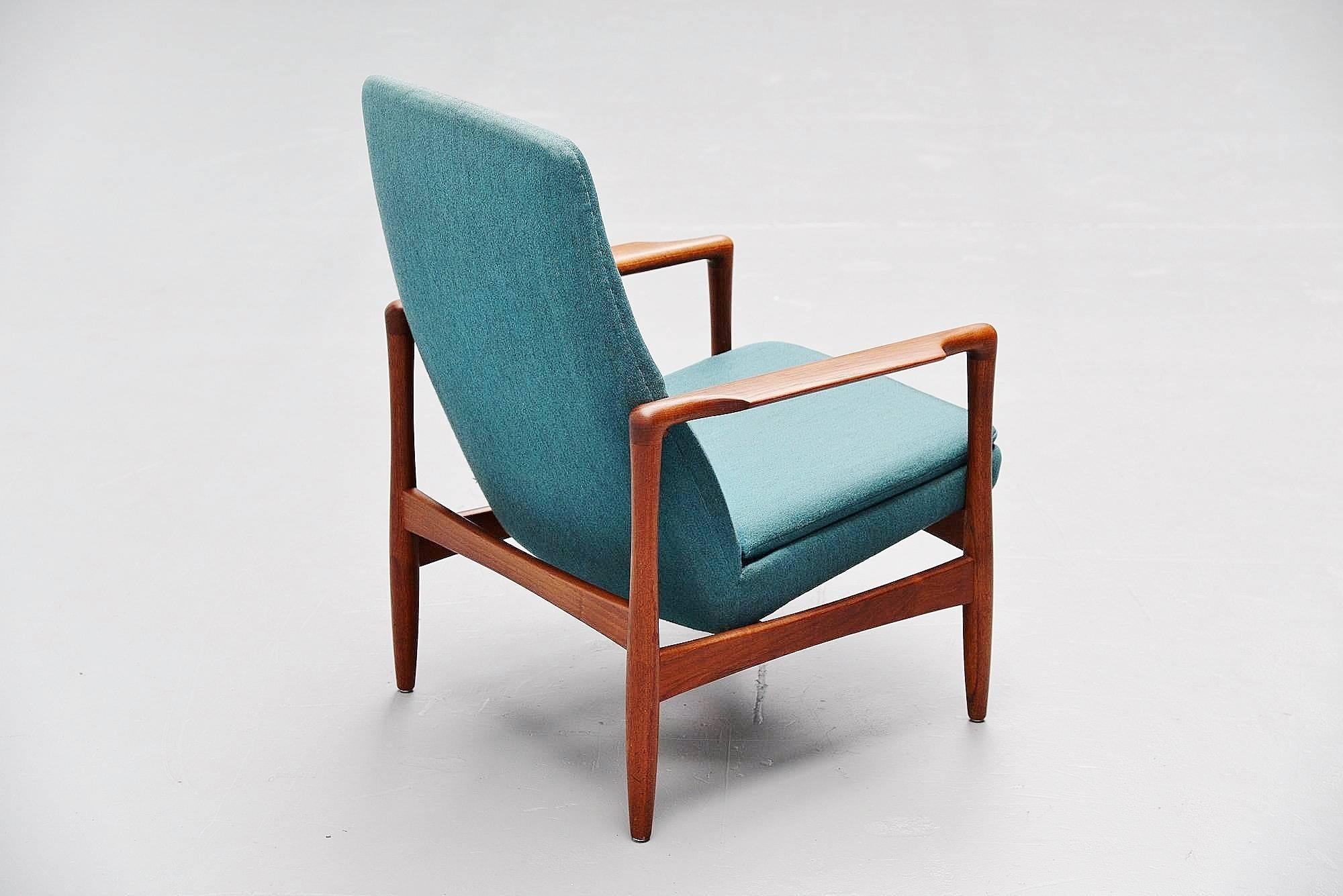 Rare easy chair designed by Ib Kofod Larsen for Selig Imports, Denmark, 1962. This chair has a solid teak wooden frame and original blue upholstery which was still in perfect condition. We just renewed the foam of the seating cushion as this was in