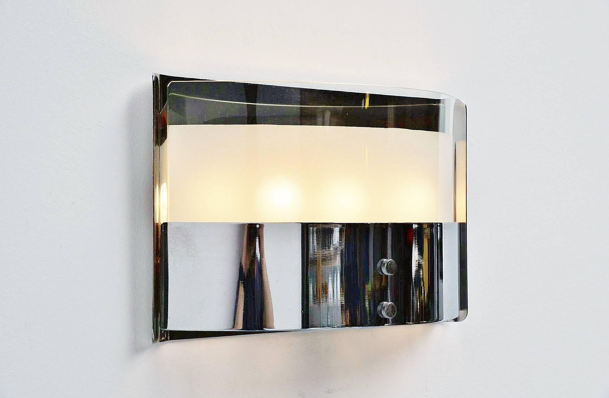 Highly decorative wall lamp designed by Luigi Caccia Dominioni, manufactured by Azucena, Italy, 1960. This wall lamp has a heavy chrome-plated frame and glass diffuser shade, partly transparent, partly frosted. This uses three light bulbs and gives