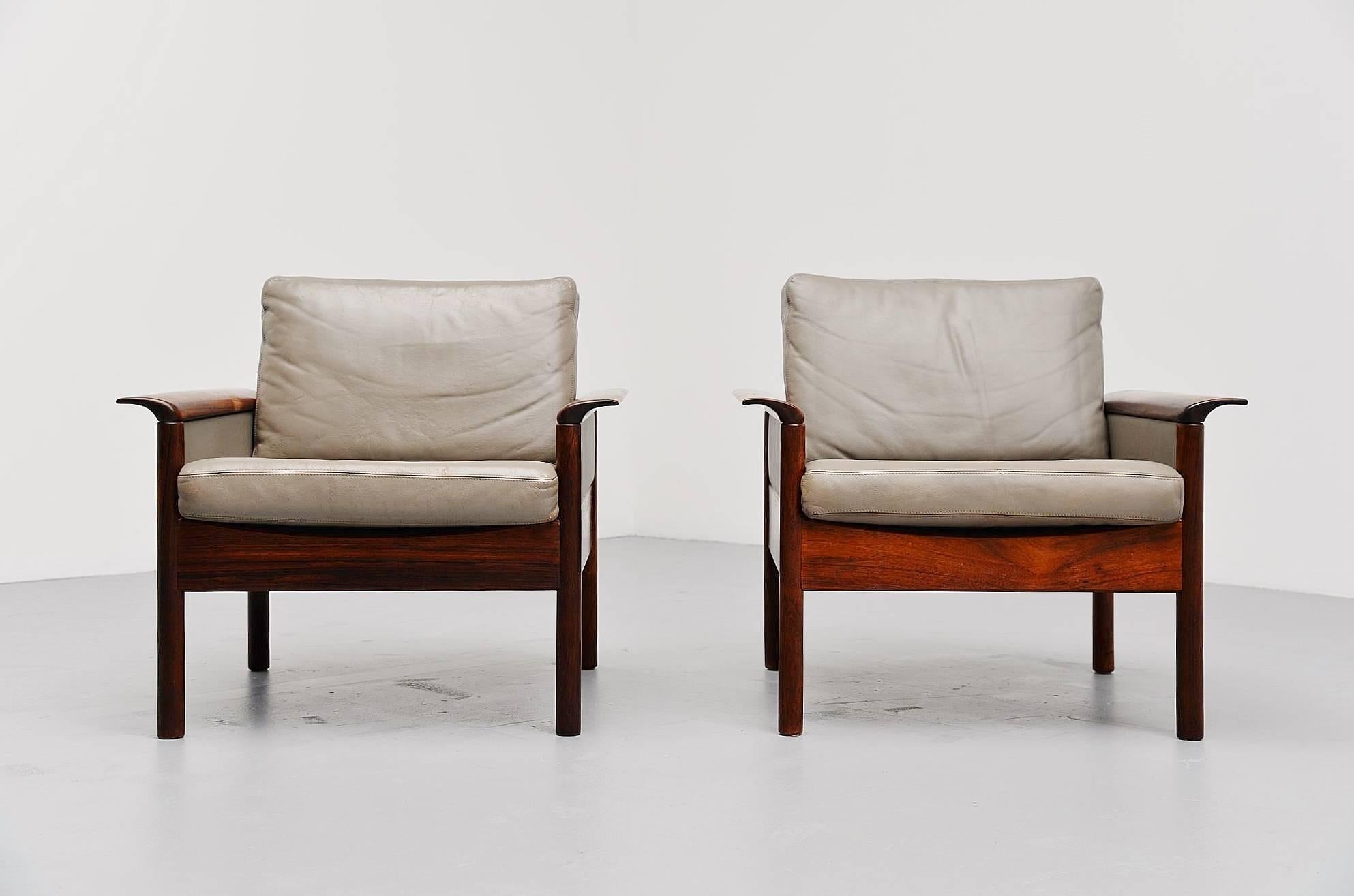 Pair of easy chairs designed by Hans Olsen, manufactured by Vatne Mobler, Denmark 1960. These chairs have solid rosewood frames and leather cushions. The cushions are newly colored in the original grey color and look great and fresh again. Minor