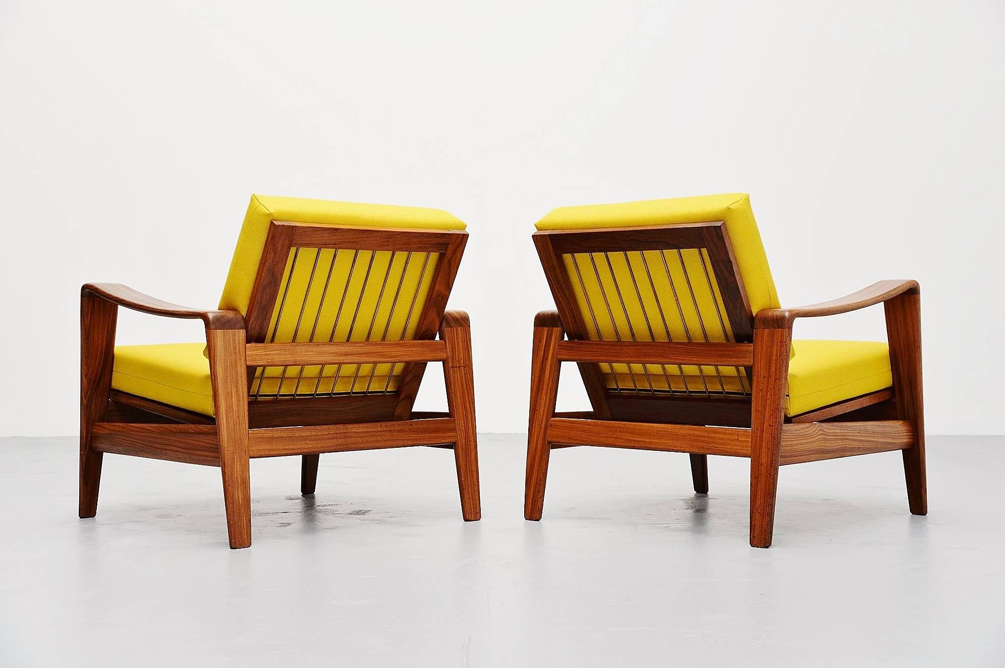 Pair of easy chairs designed by Arne Wahl Iversen, manufactured by Komfort, Denmark, 1960. These chairs have solid teak wooden frames and yellow upholstered cushions. These organic and dynamic shaped chairs look great in contrast. Nicely shaped