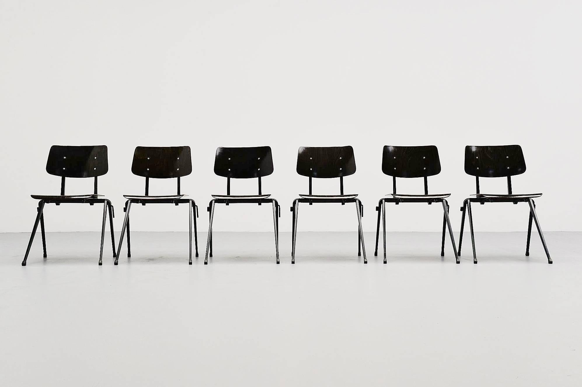 Large set of Industrial stacking chairs designed and made by Galvanitas Oosterhout, Holland 1970. These chairs have black lacquered metal frames with rubber feet and an black pagwooden seats and backs. This is for a nice and large set of 60 chairs