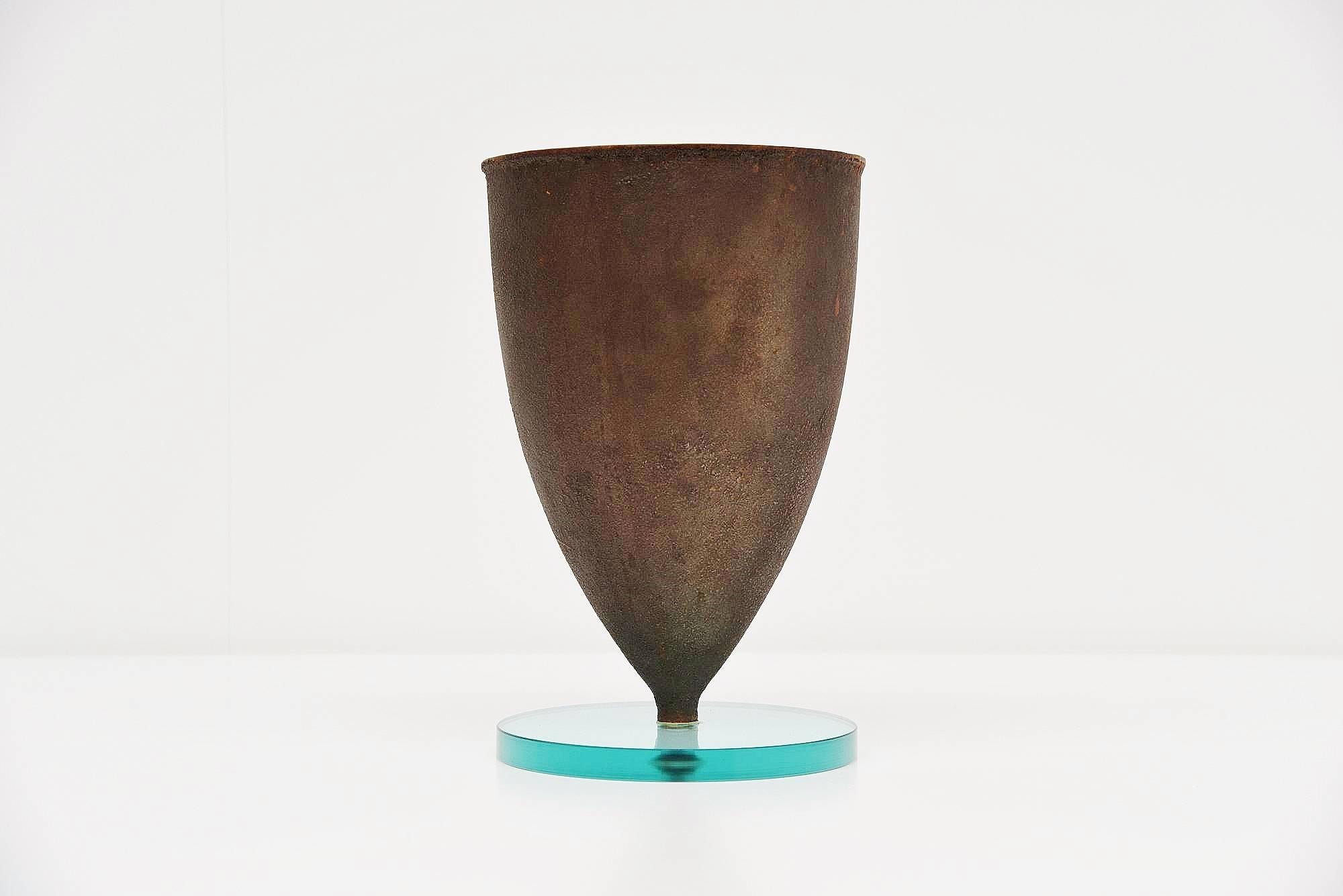 Beautiful large and decorative vase designed by Michele De Lucchi and manufactured by Produzione Privata, Italy 1997. The contrast between the base in ground transparent glass which retains it's lightness and the heavy, cast iron conical cup,