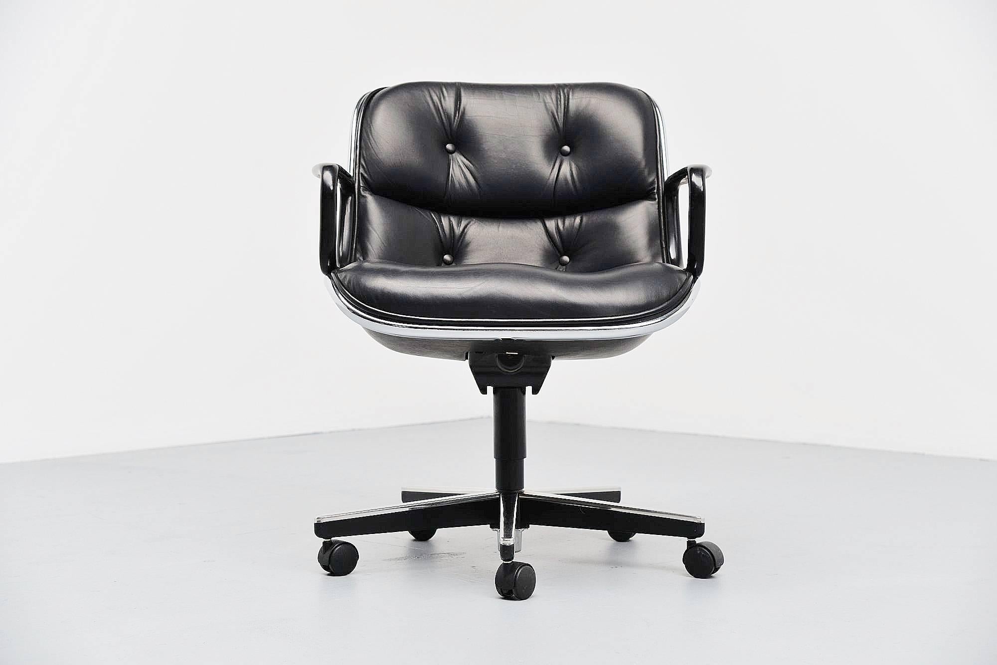 Comfortable executive desk chair designed by Charles Pollock and manufactured by Knoll International, United States, 1963. This desk chair is made of high quality black leather, has a chrome-plated rim and Bakelite arms. The chair swivels and tilts