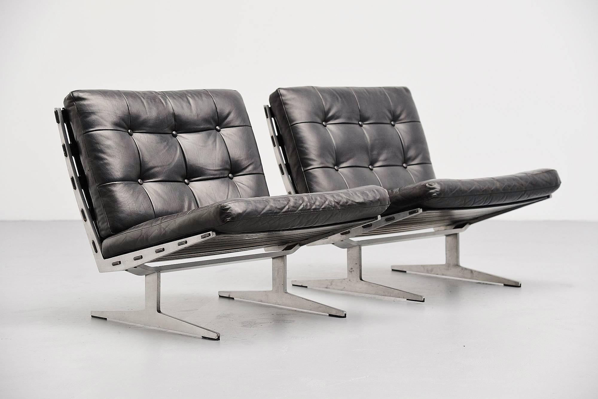 Excellent pair of lounge chairs designed by Paul Leidersdorff and manufactured by A. Leidersdorffsen A/S, Denmark, 1965. These chairs are made of solid aluminium slipper frames, with black lacquered plywood seat and back and tufted leather cushions.