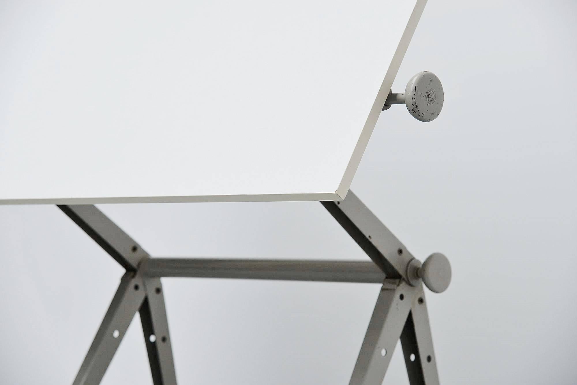 Ingenious drafting table designed by Wim Rietveld and Friso Kramer for Ahrend de Cirkel, Holland, 1963. The table is adjustable in numerous positions using an ingenious adjusting system using only two screws at the side. This table won a ´Signe