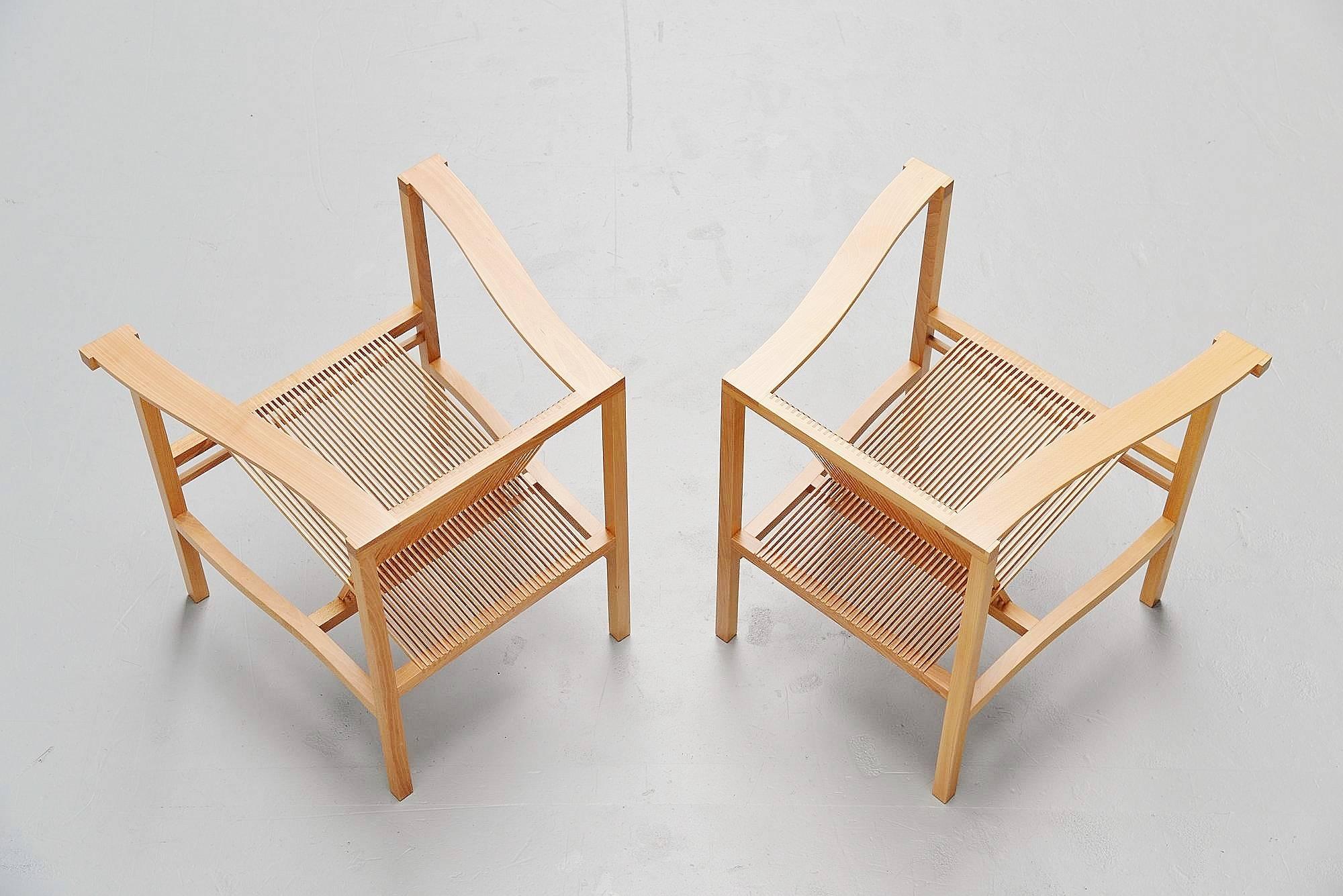 Rare high slat armchair pair designed by Ruud Jan Kokke, produced by Metaform, 1984. These chairs were produced by Metaform for 17 years and only on request because the production was too costly. This is for a very nice pair of beech wooden chairs.