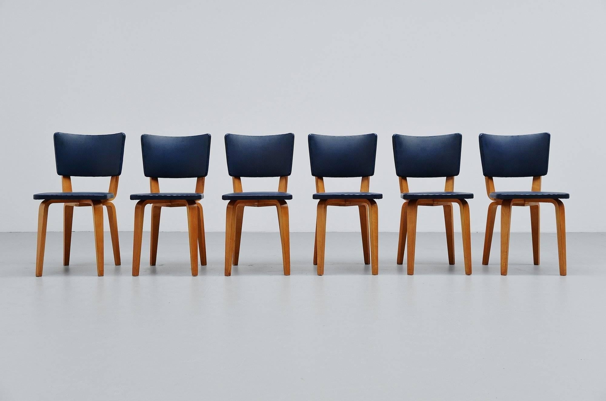 Nice and original set of six dining chairs designed by Cor Alons and manufactured by Gouda Den Boer, Holland 1949. These chairs are model 500 and have birch plywood frames with original dark blue faux leather upholstery. The upholstery is compared
