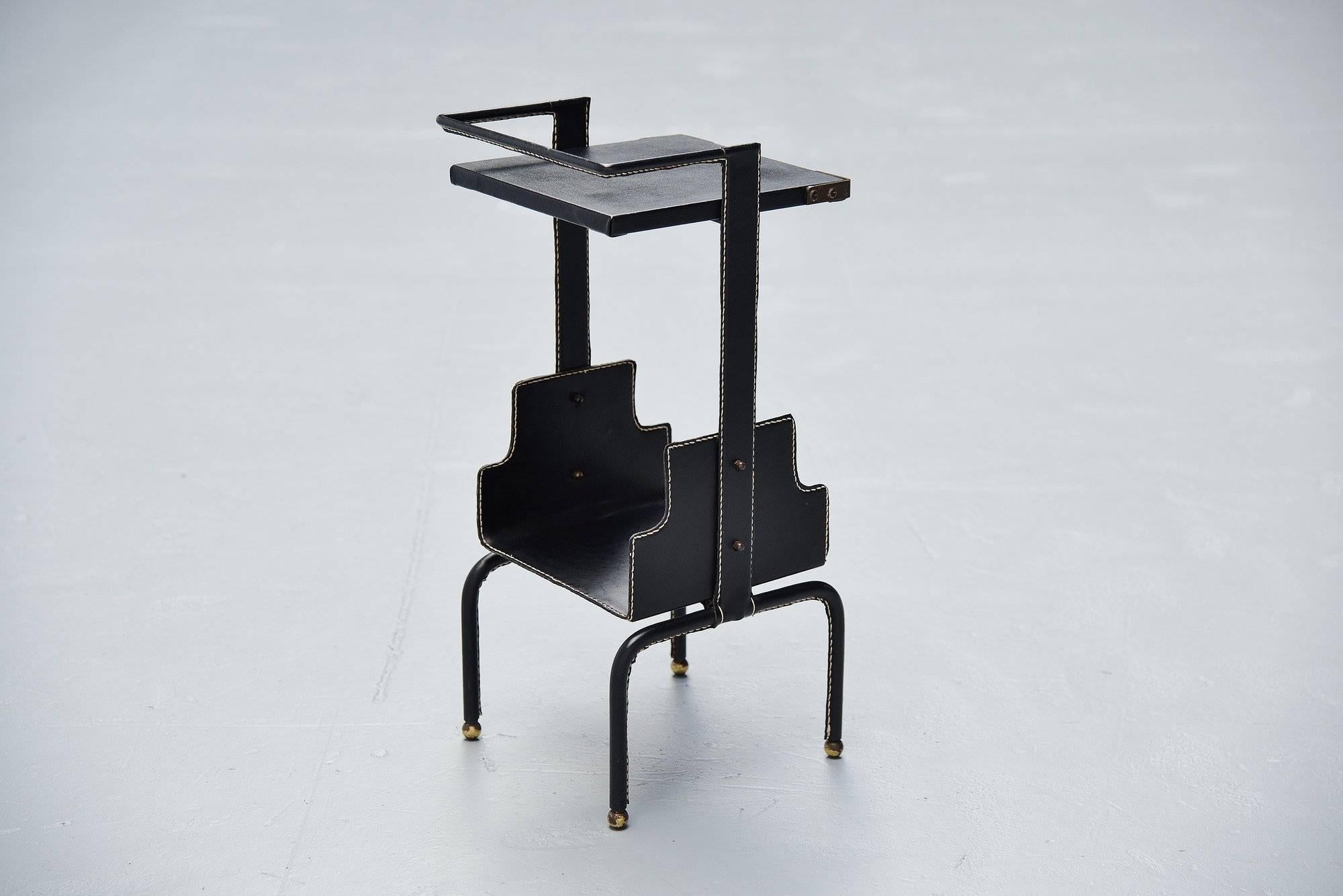 Very nice black leather side table designed by Jacques Adnet and manufactured by Ateliers Jacques Adnet, France, 1950. This side table was originally used as telephone table. But can be used as sofa table or bedside table for example. This table is