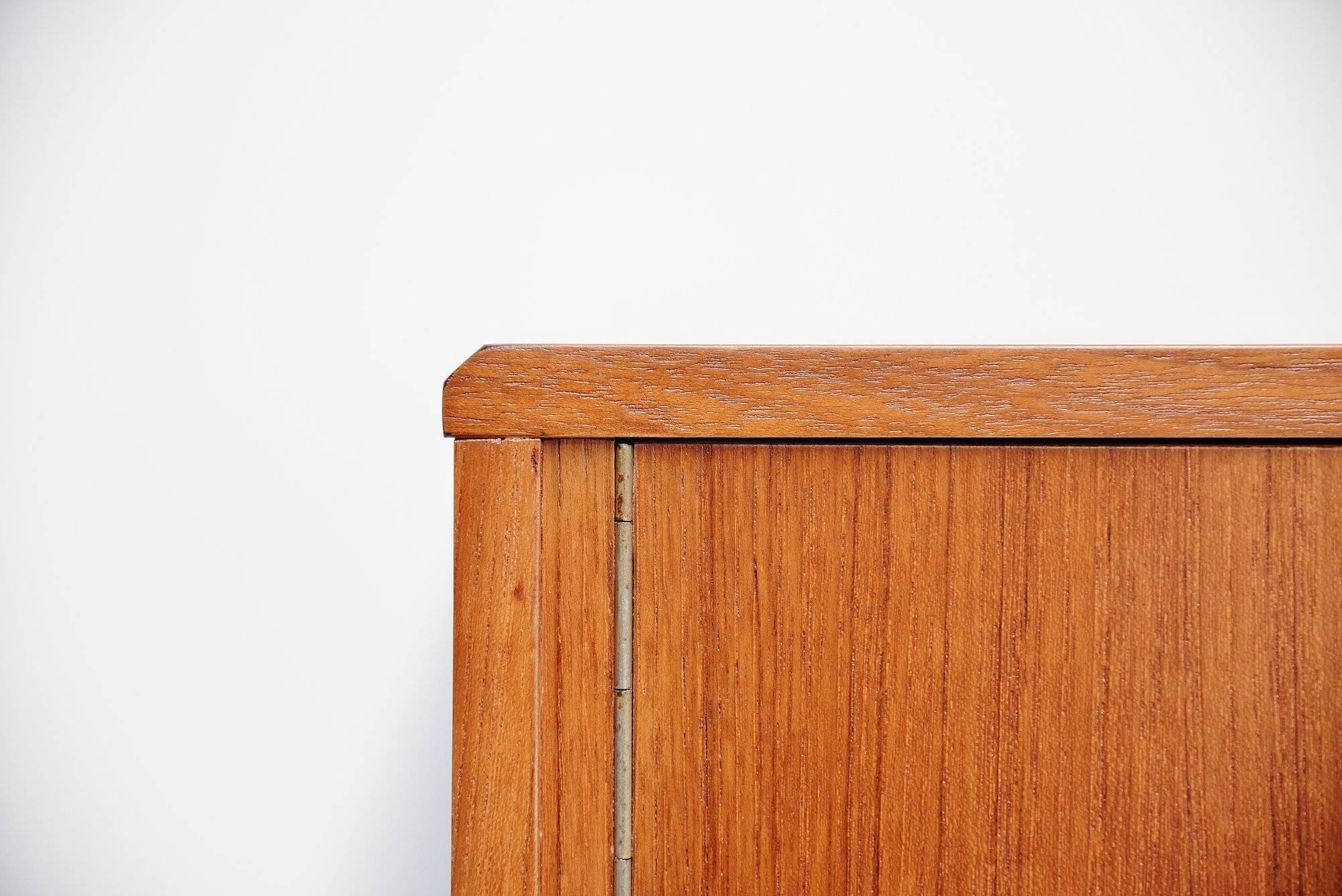 Nice small credenza or dressing table designed by Aksel Kjersgaard and manufactured by Odder Mobelfabrik, Denmark, 1955. This credenza is made of teak wood and has very nice Danish lines. There are two folding doors on the left and a drawer on the