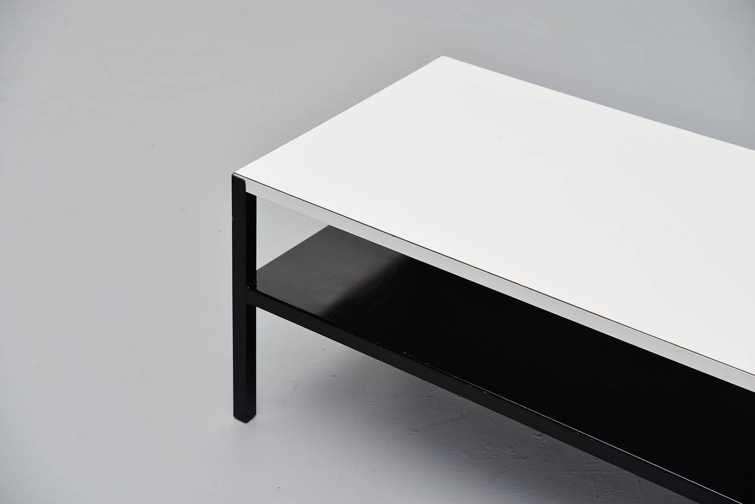 Very nice Industrial coffee table designed by Wim Rietveld for Ahrend de Cirkel, Holland, 1960. This table was model Regal, designed in 1960 and it has a black lacquered metal frame with Ahrend stamp on it. The top is made of white laminated wood.