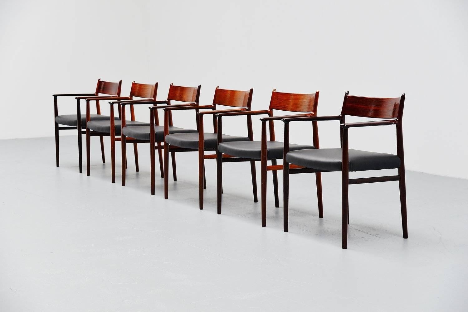 Nice set of six armchairs designed by Arne Vodder for Sibast Mobler, Denmark 1965. These chairs are made of solid rosewood and they are newly upholstered with high quality black leather from Hulshoff. These chairs look amazing with the arms, highly