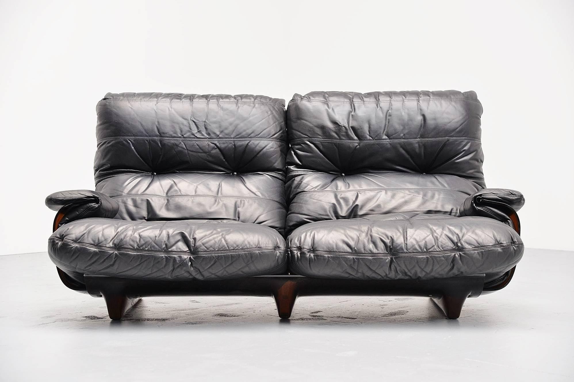 Large lounge sofa designed by Michel Ducaroy, manufactured by Ligne Roset, France, 1970. This is from the Marsala series and this has a brown plexiglass base and very cosy black leather cushions. Super comfortable lounge sofa in high quality