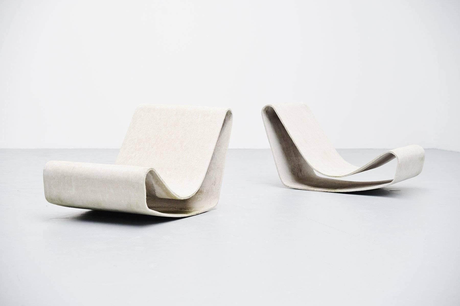 Very nice pair of low lounge chairs designed by Willy Guhl for Eternit, Switzerland 1954. These iconic garden chairs designed by Willy Guhl are made of cellulose infused fiber cement like concrete, which is nearly indestructible. These chairs are in