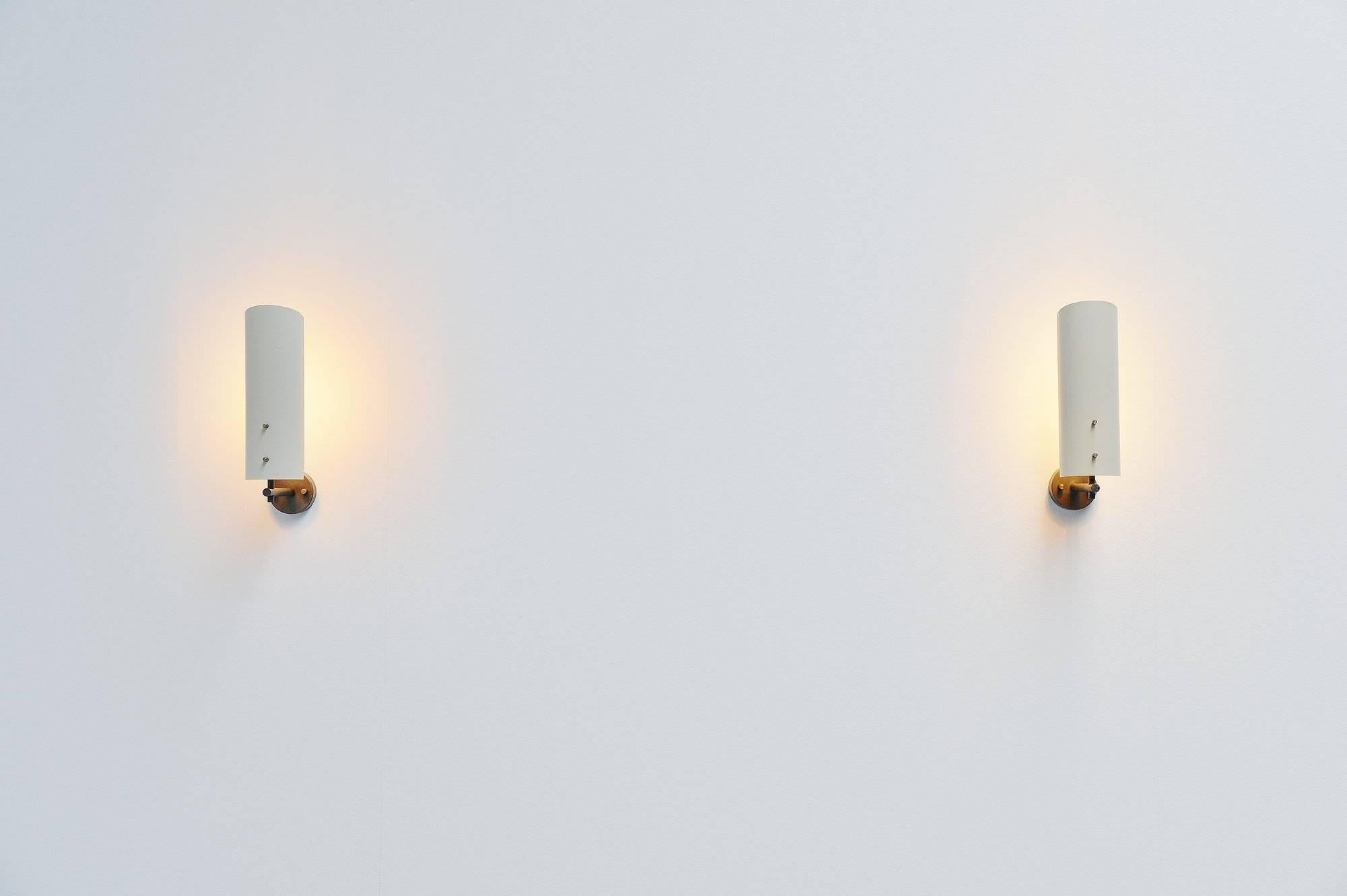 Rare pair of wall lamps model 7082 designed by JJM Hoogervorst for Anvia Almelo, Holland 1955. These lamps have a grey painted arm and off-white painted shade. The shade can rotate for a different light beam. Very nice pair, can be used as bed lamps