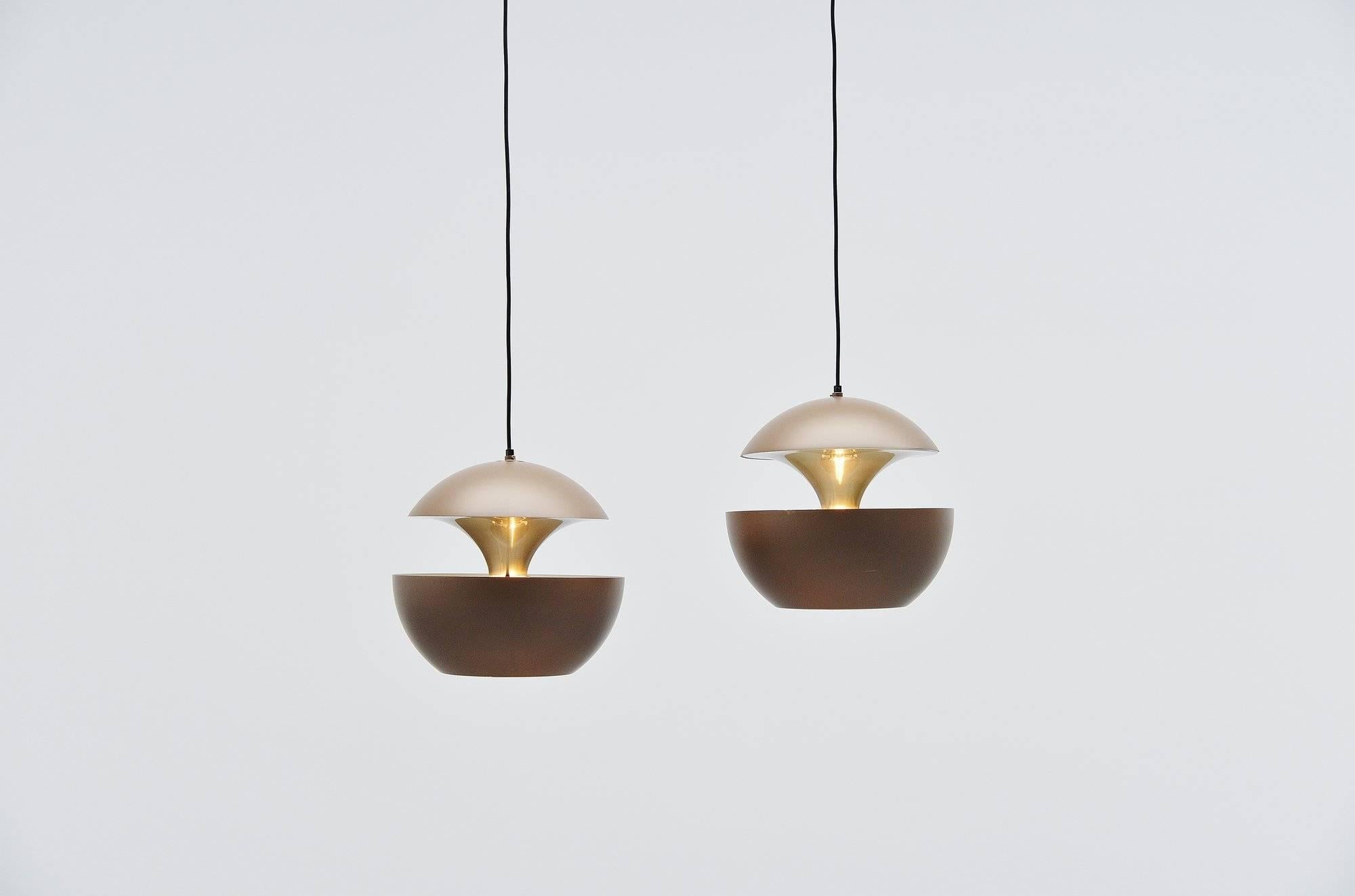 Large set of pendant lamps designed by Bertrand Balas and manufactured by RAAK Amsterdam, Holland 1970. These lamps are also called 'Springfontein' in Dutch, or fontaine jaillissante. The lamps have a brown painted shade and gold anodized inside for