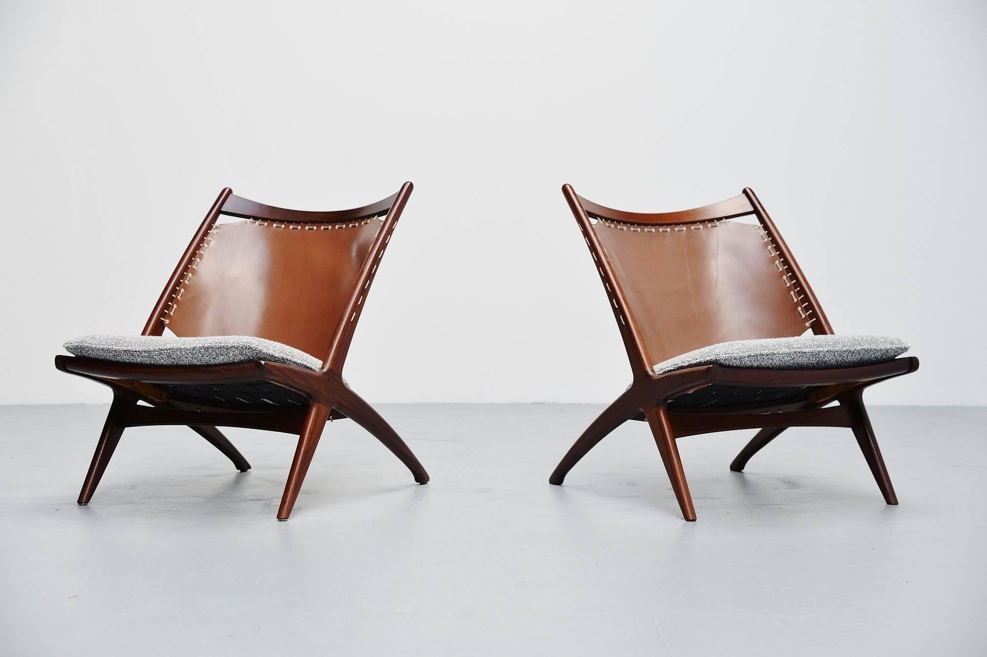 Rare pair of lounge chairs designed by Frederik Kayser and manufactured by Gustav Bahus, Norway, 1955. The chairs have a solid teak wooden frame and a very nice leather back fixed to the teak wooden frame with a white rope. The seats are