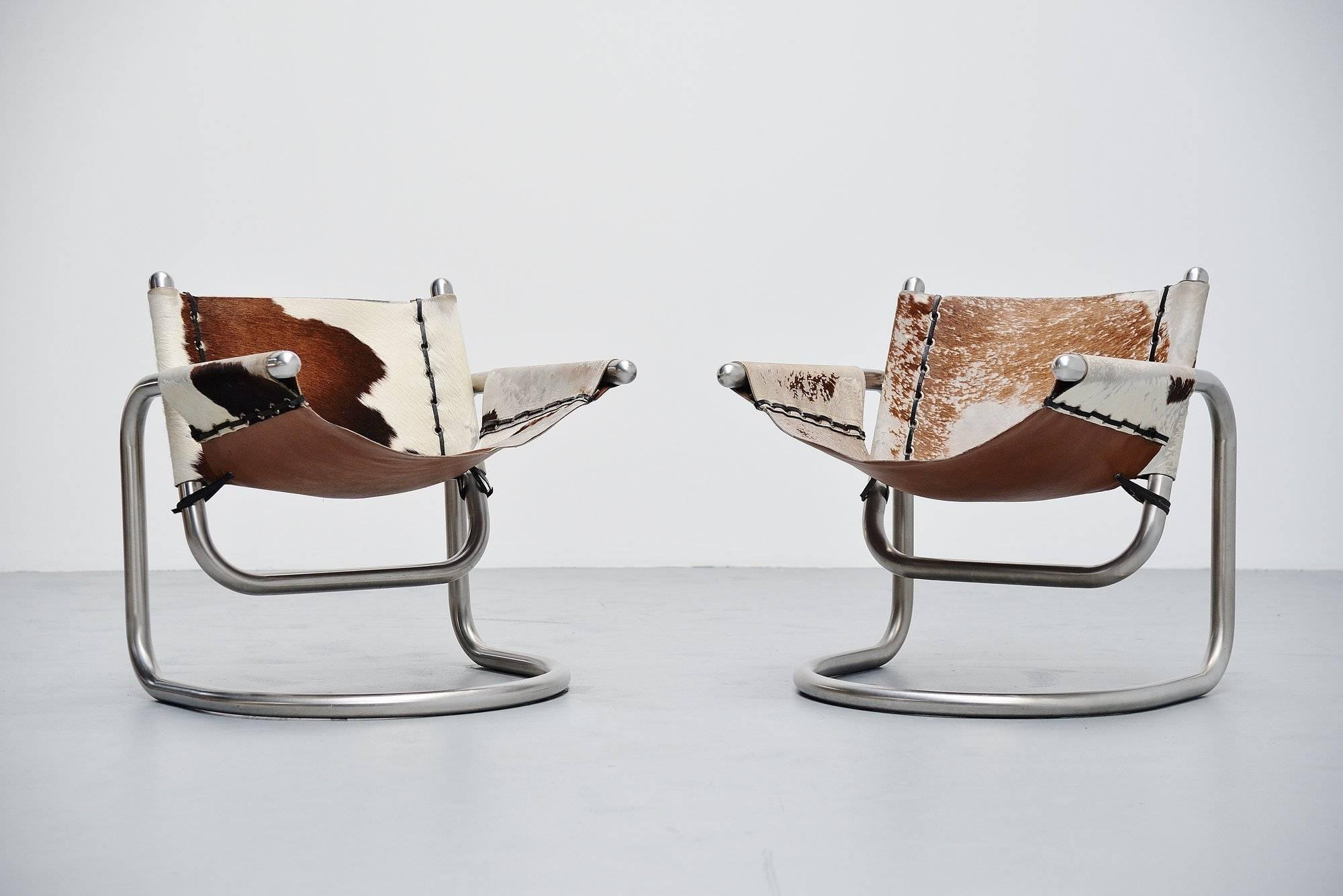 Very nice and unusual pair of lounge chair designed by unknown designer or manufacturer, Italy, 1970. The chairs have a brushed steel tubular metal frame and cow skin upholstered seat with leather laces. The chairs have a very nice and unusual