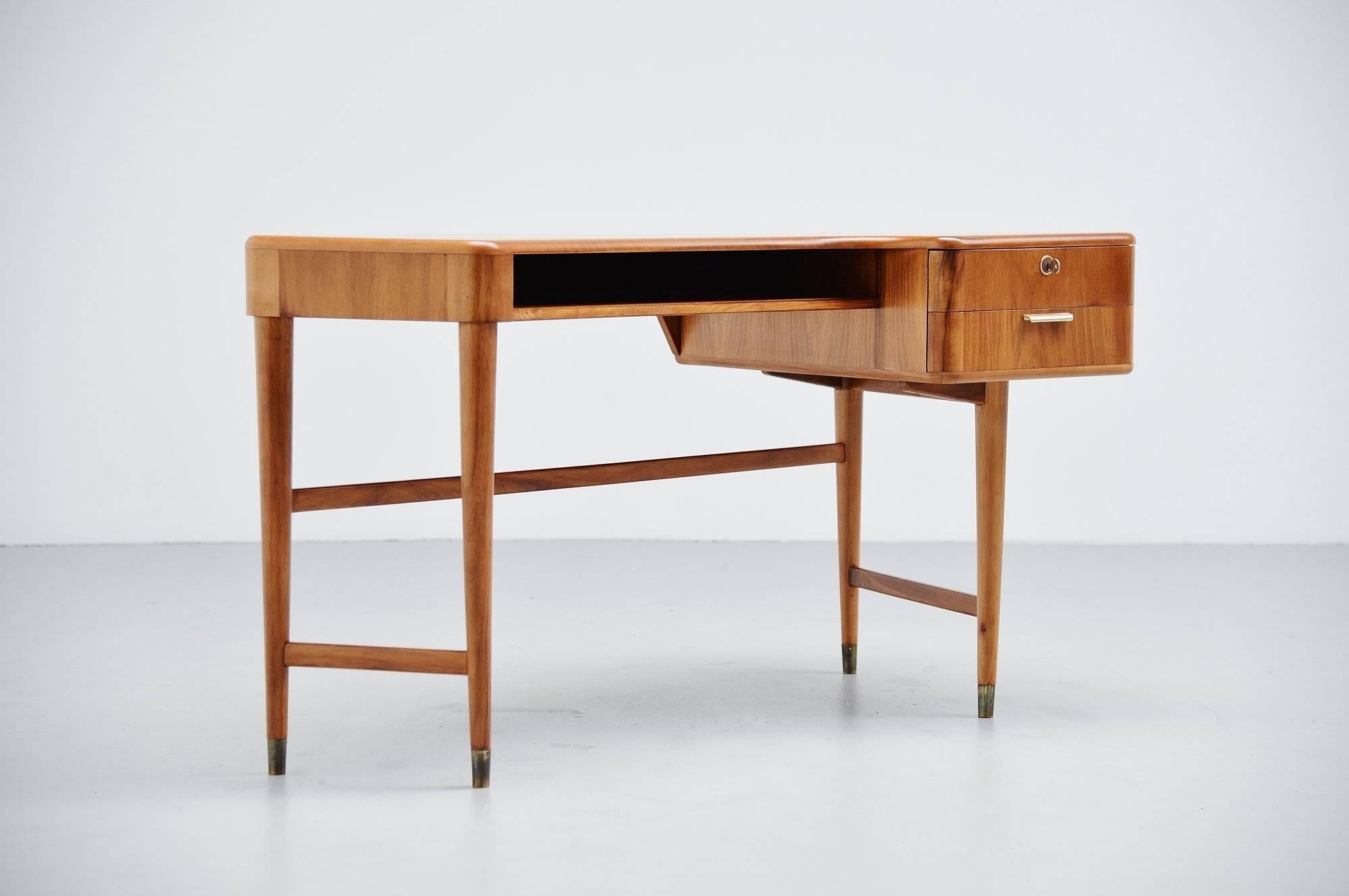 Very nice kidney shaped ladies desk designed by A.A Patij and manufactured by Zijlstra's Meubelen, Holland, 1950. This desk was made of walnut wood and has some brass details, the feet for example. In the middle there is an open storage space and on