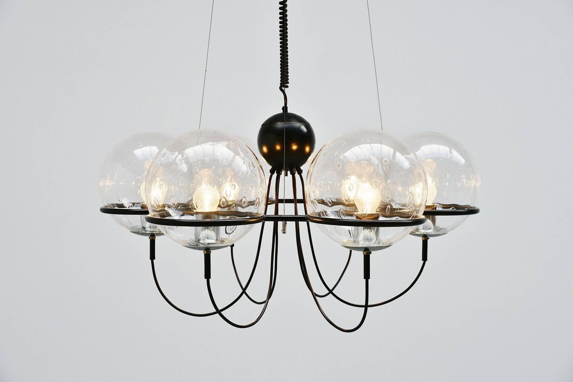Very nice and impressive chandelier designed and manufactured by Raak Amsterdam, Holland, 1975. This chandelier has a black painted metal frame that supports the glass raindrop globes. The lamp hangs on three wires, we mounted it on a black ceiling