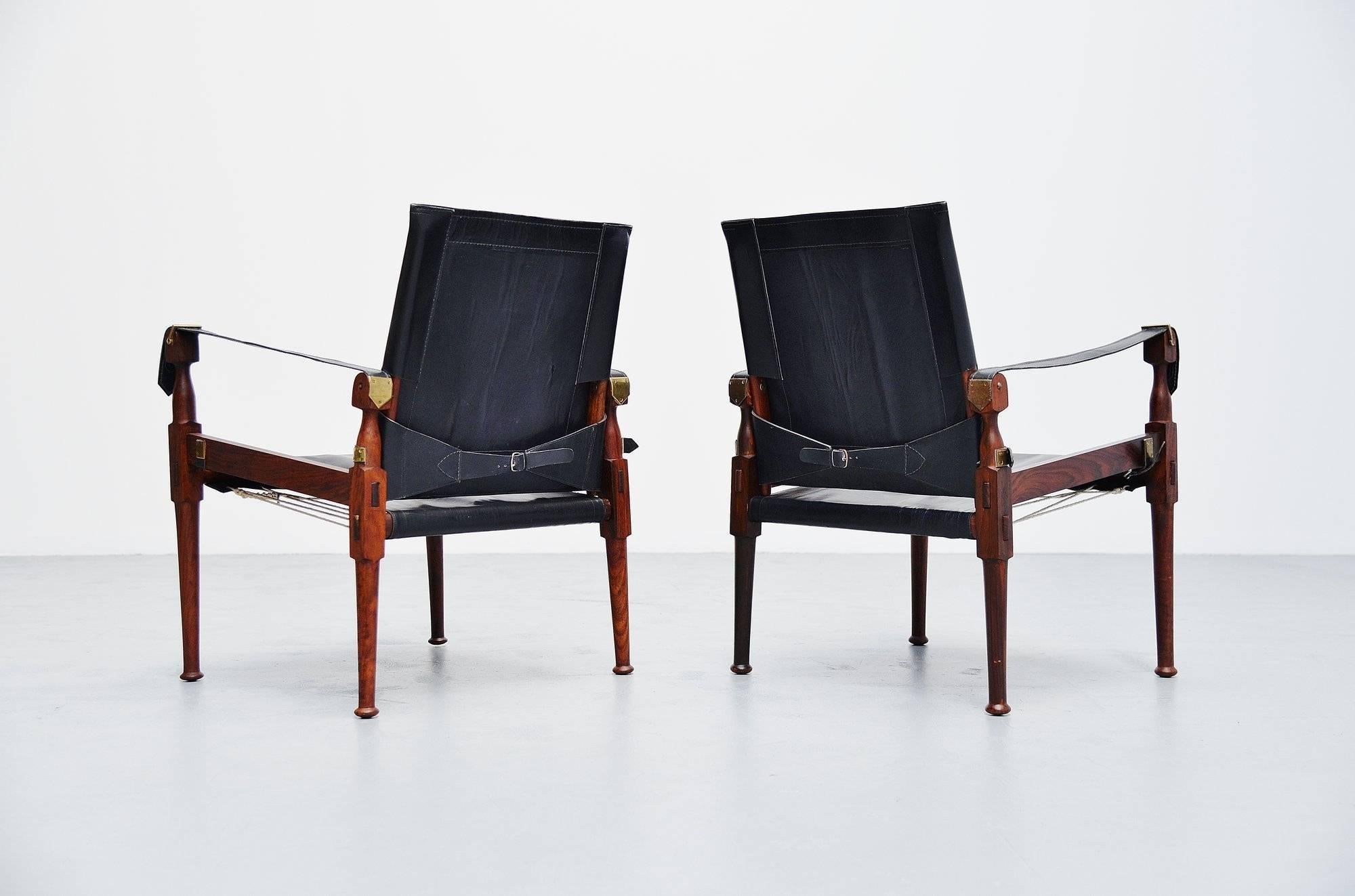 Very nice pair of so called safari chairs designed and manufactured by M. Hayat & Brothers, Pakistan 1970. M. Hayat & Brothers produced a lightweight, portable armchair based on the model of the English officers' chairs. These chairs are easy to